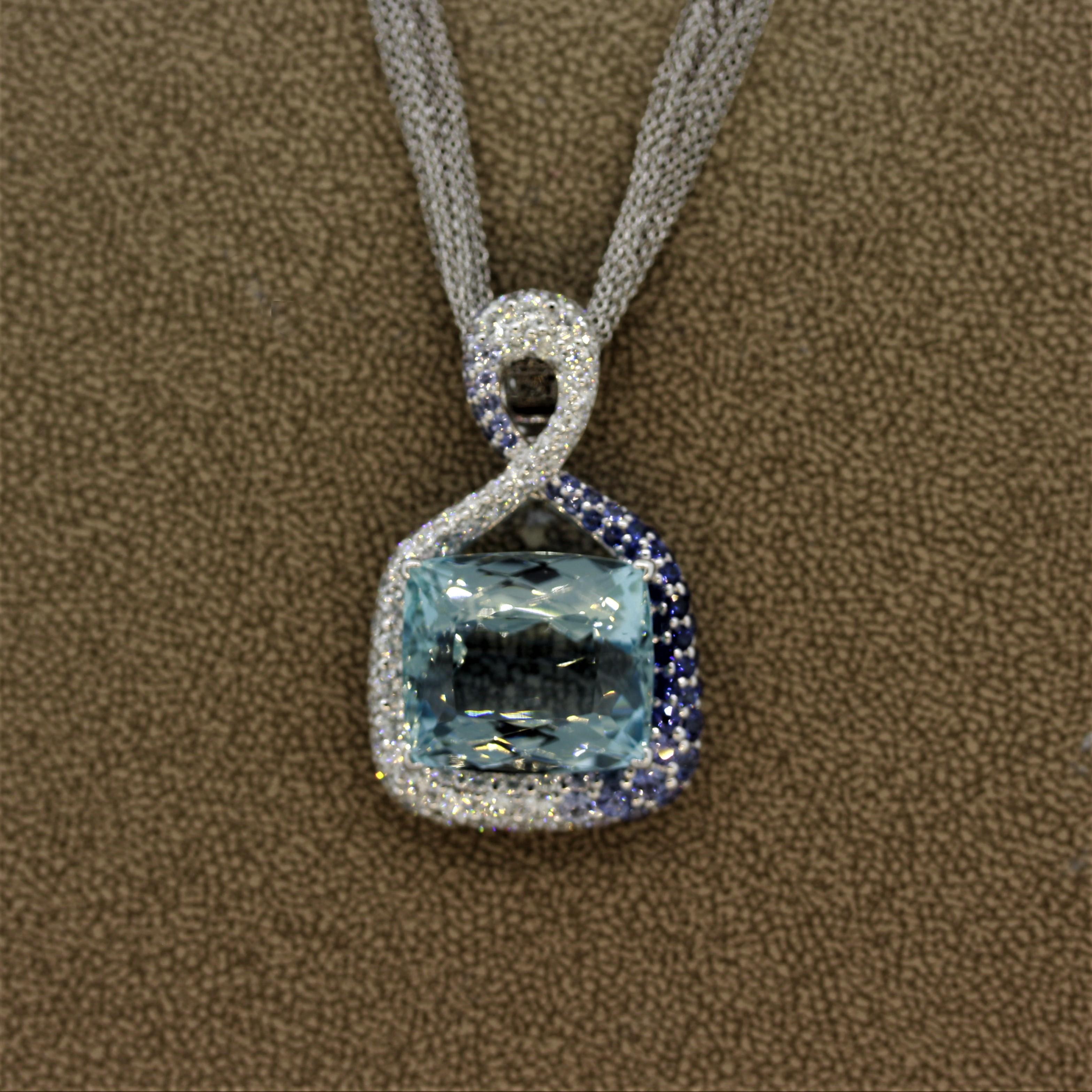 One of our favorite pieces in our collection! This one of a kind pendant features a superb gem quality aquamarine weighing 30.04 carats. It is framed in 18k white gold with diamonds and blue sapphires set around it. There are 2.00 carats of blue
