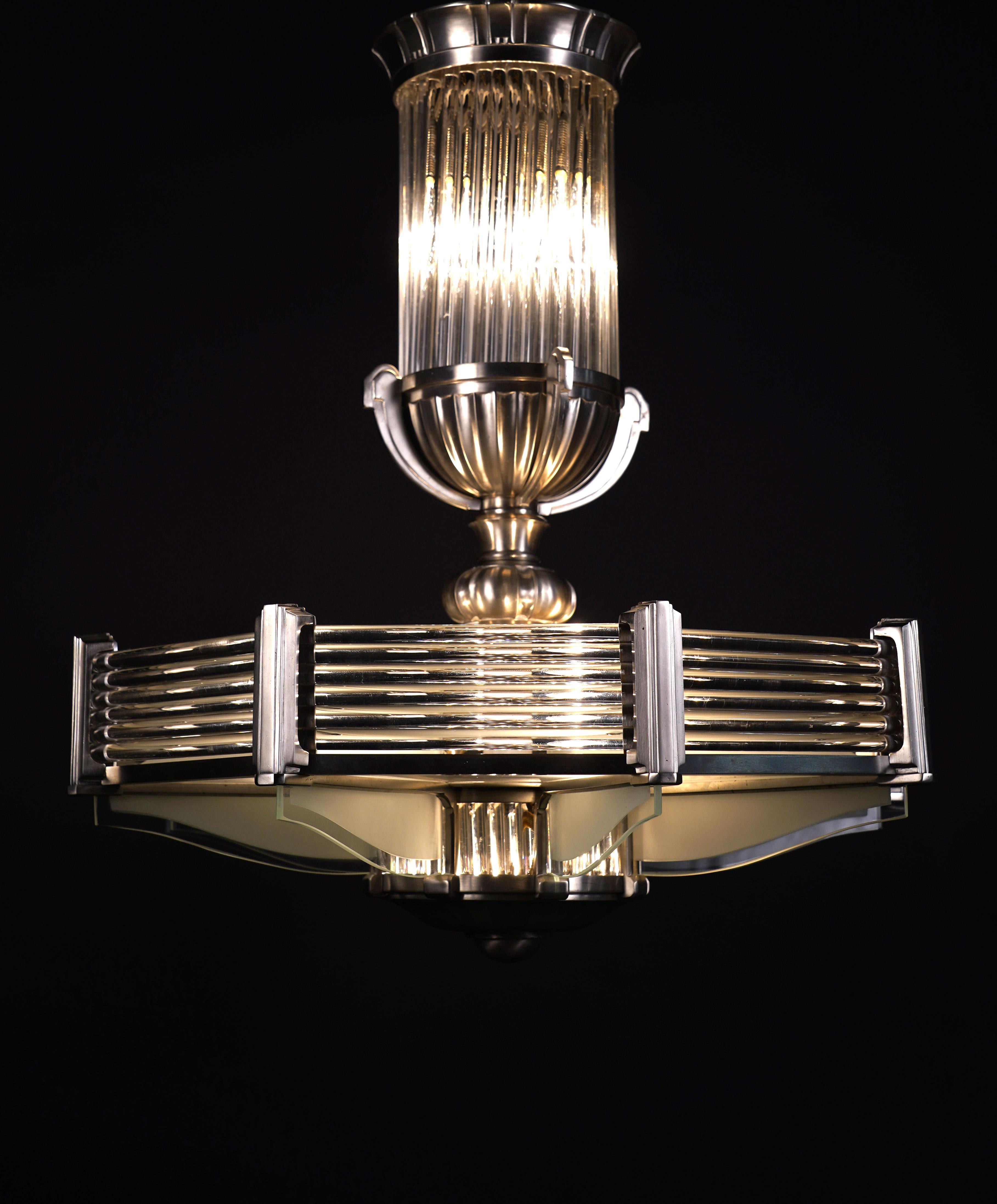 Fine octogonal shaped Art Deco chandelier with eight nickel-plated bronze lights, the whole attractively decorated with glass rods and frosted glass panels.

Biography :
Ateliers Petitot was founded in Paris in 1860 by Eugène Petitot, who began