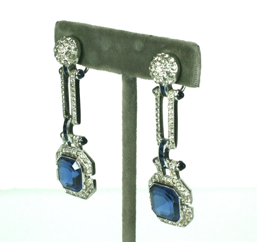 Fine Art Deco earrings from the 1930's. Wonderful articulated design with large square cut faux sapphires falling from pave links with sapphire accents. 
Beautifully detailed connectors with calibre set faux sapphires and bullet cab terminals.