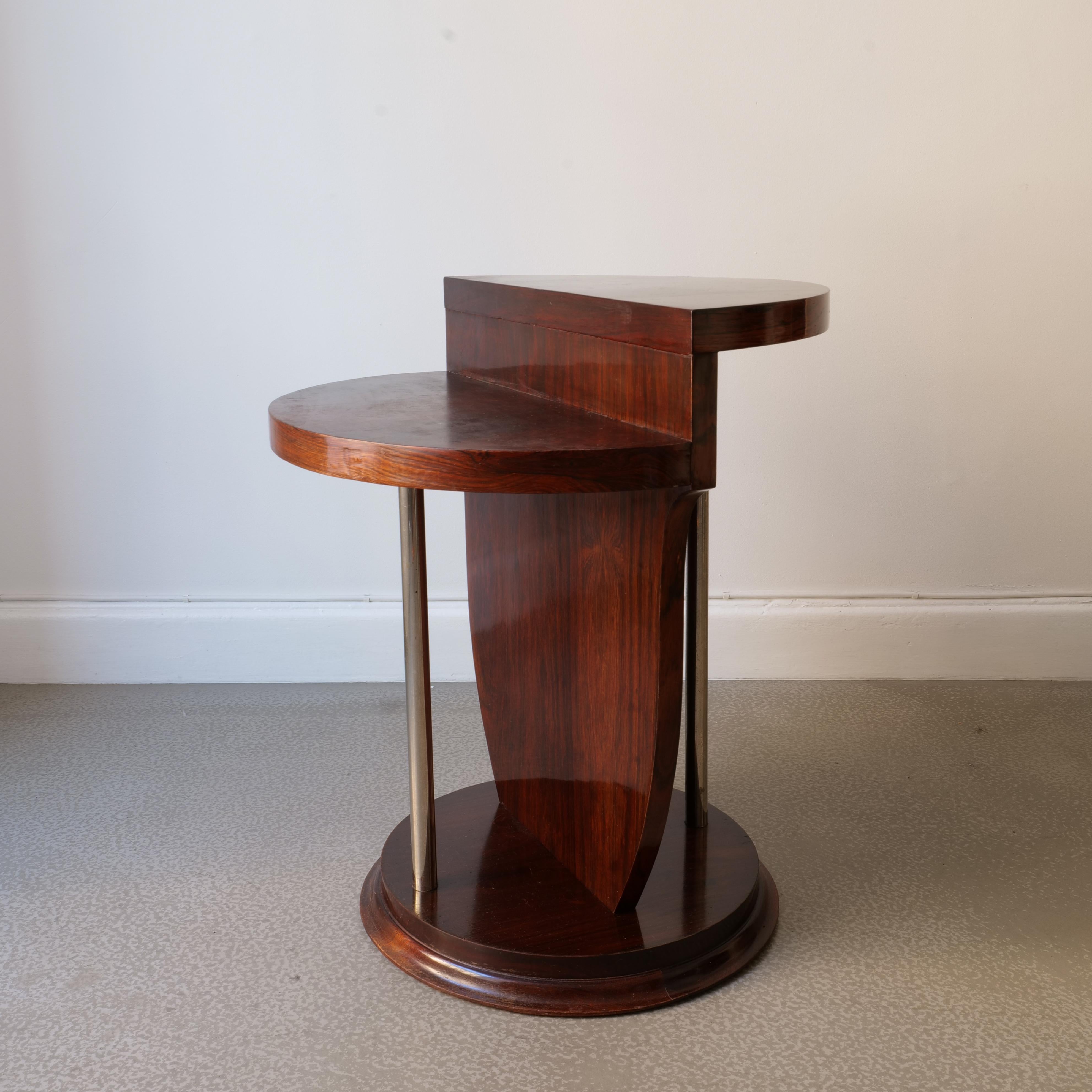 A wonderful two-tiered occasional table attributed to the french master of deco furniture, Jules Leleu (1883-1961). This table is a superb example of fine cabinetry from the Belle Époque period made in a fine walnut veneer with chromed pillars.
