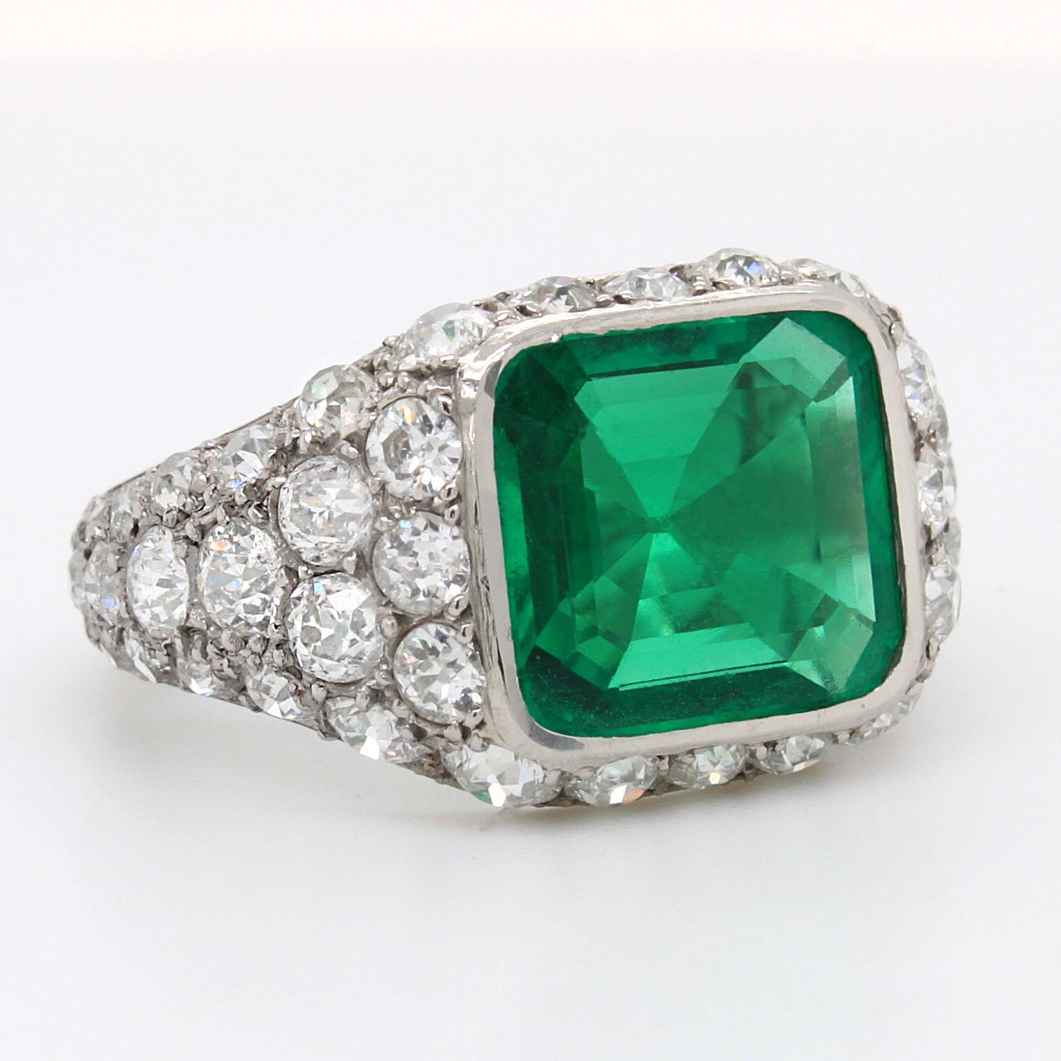 An old mine Colombian emerald and diamond ring in 18k white gold. The antique cushion cut emerald has a strong crystal and beautiful deep and vivid green colour adding to the allure of the gemstone. It weighs approximately 2.85 carats and is of