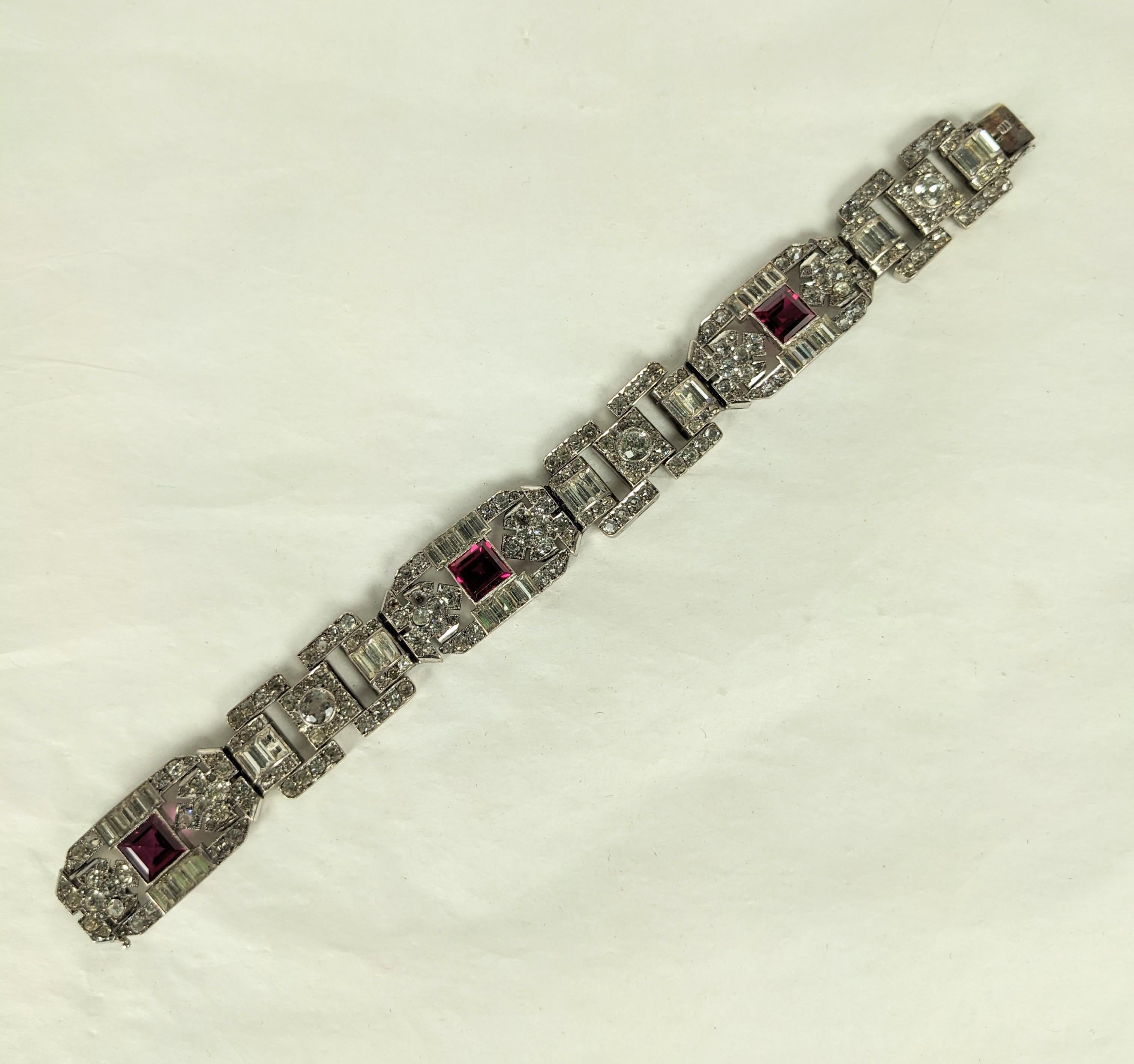 Incredible Art Deco Ruby and Crystal Paste Bracelet set in sterling silver from the 1930's. Alternating plaques of Deco motifs with round, baguette and square cut pastes, set in sterling with 18ct clasp and safety.  1930's France 7.5