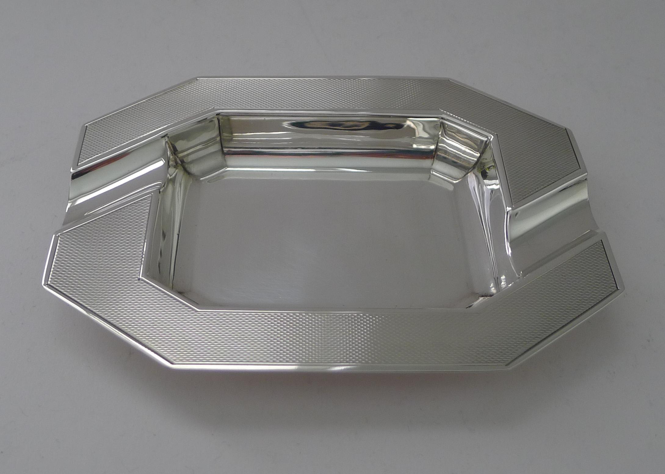 A handsome and stylish ashtray in solid English silver in a striking Art Deco design with engine turned decoration.

The silver is fully hallmarked for Birmingham 1950 together with the makers mark for the well renowned silversmith, William