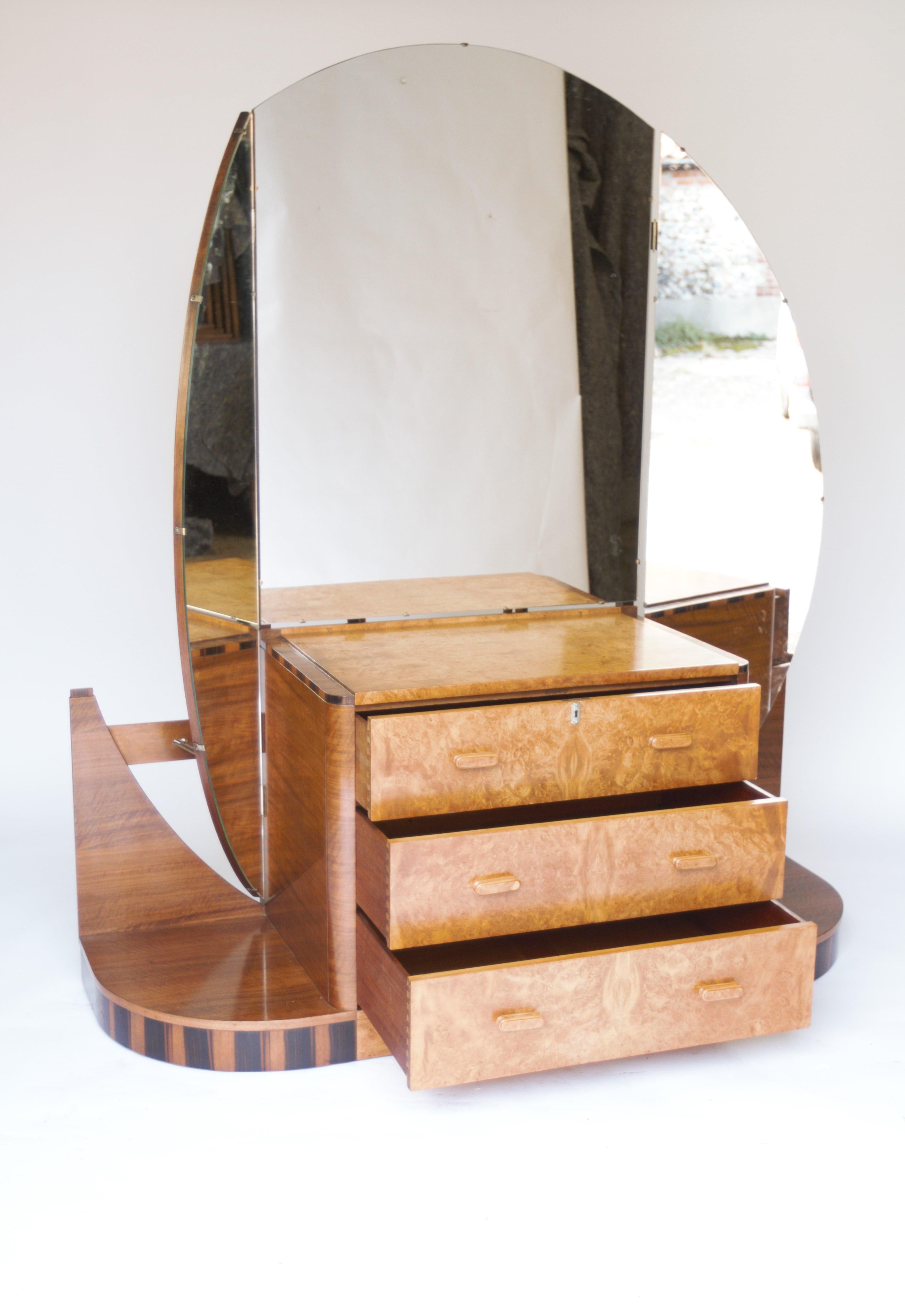 Fine Art Deco Walnut & Burr Walnut Dressing table & stool
circa 1930.
Burr Walnut 3 drawer centre chest, with Rosewood banding around top
Round corner  Walnut platform base each side with Coromandel veneer at base,
Fixed Centre mirror with pair