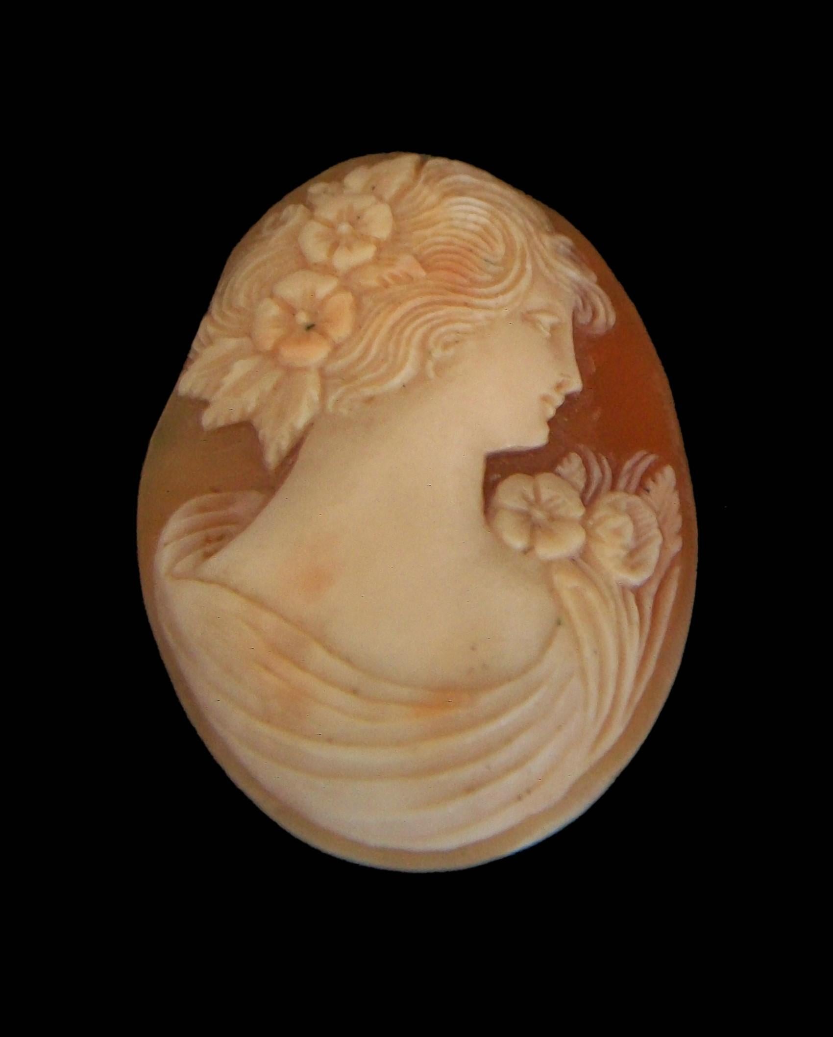 Antique Art Nouveau shell cameo - hand carved with fine detail - featuring a profile of a woman with flowers in her hair and on her shoulder with classical draped bodice - unmounted - Italy - circa 1900.

Excellent antique condition - irregular