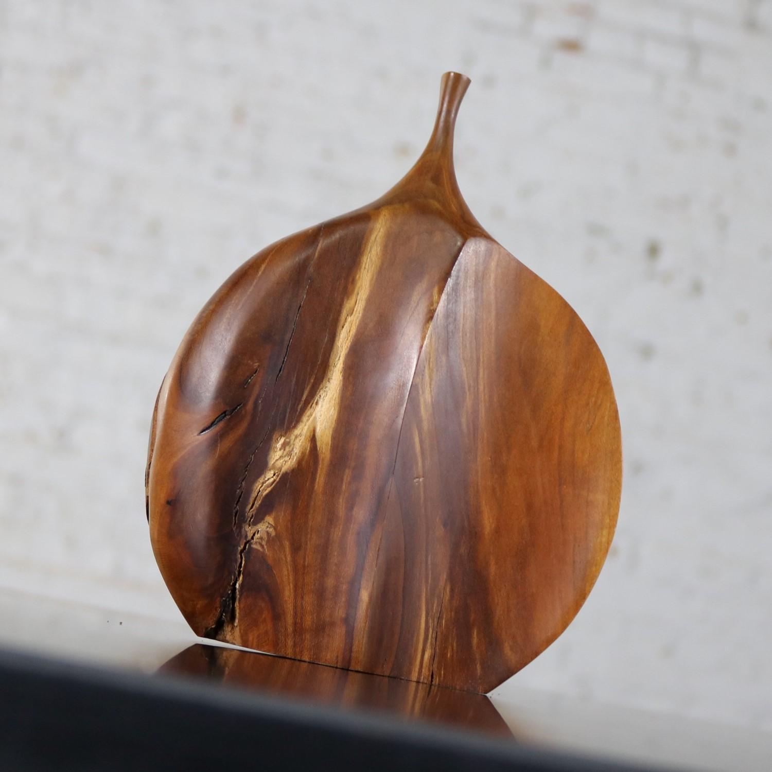 Handsome Mid-Century Modern asymmetrical weed vase by Doug Ayers. This Fine art turned apricot wood piece has natural bark on one side and a smooth peaked surface on the other. It is signed and dated 7/14/69. It is in wonderful vintage condition