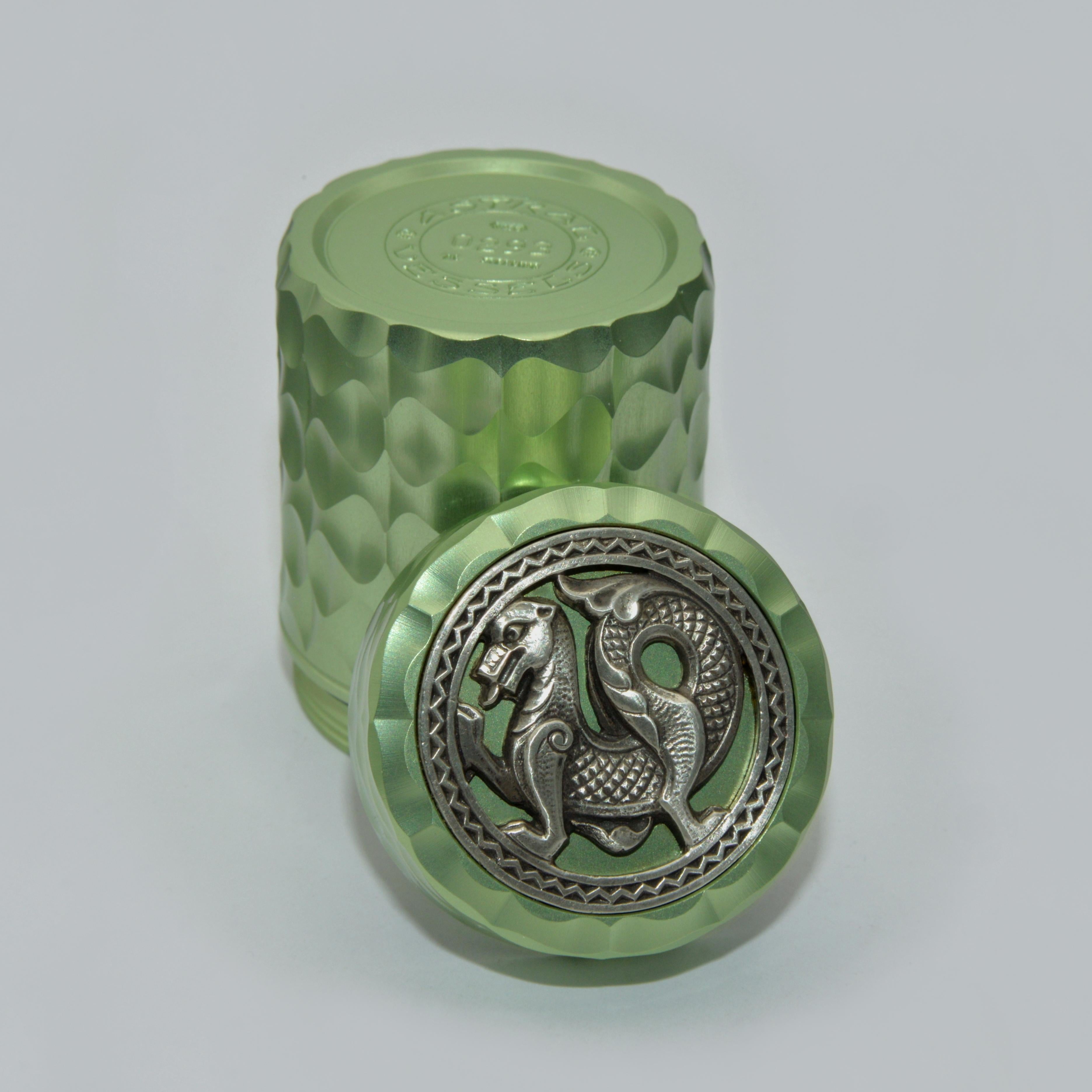 This vessel features a single, fabulous ornamental pattern that was carved onto nearly every surface using our antique Rose Engine. 
 
The Sterling Silver and rustic Welsh Dragon medallion was cast from an original carved in relief by James