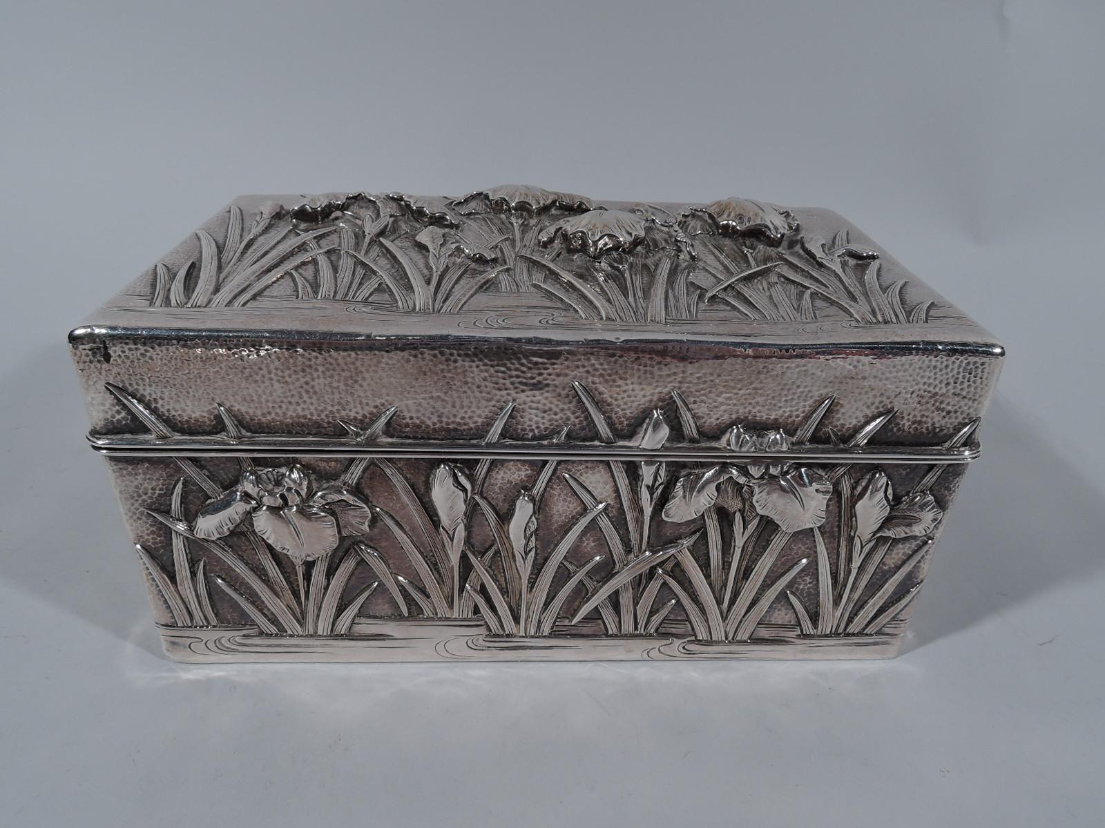Turn-of-the-century Japanese sterling silver casket box. Retailed by Arthur & Bond in Yokoyama. Rectangular with hinged cover. Cover top and sides decorated with iris flowers set in eddying water. Ornament applied, chased, and engraved; ground