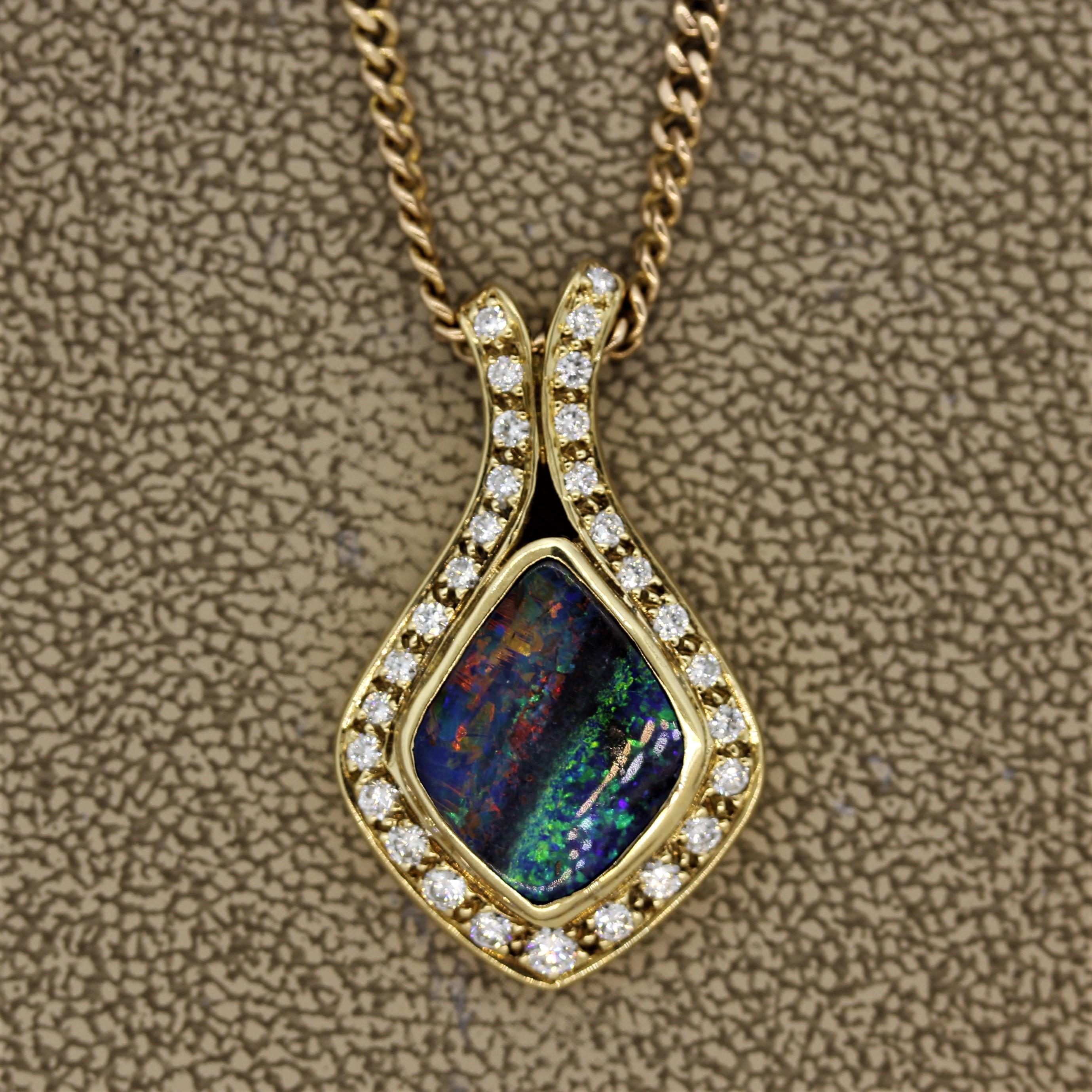 A superb boulder opal from Australia takes center stage in this fabulous pendant. The opal weighs approxemtly 3 carats and has excellent play of color. The left half of the opal shows an array of multi-colors including red, orange, green and blue,