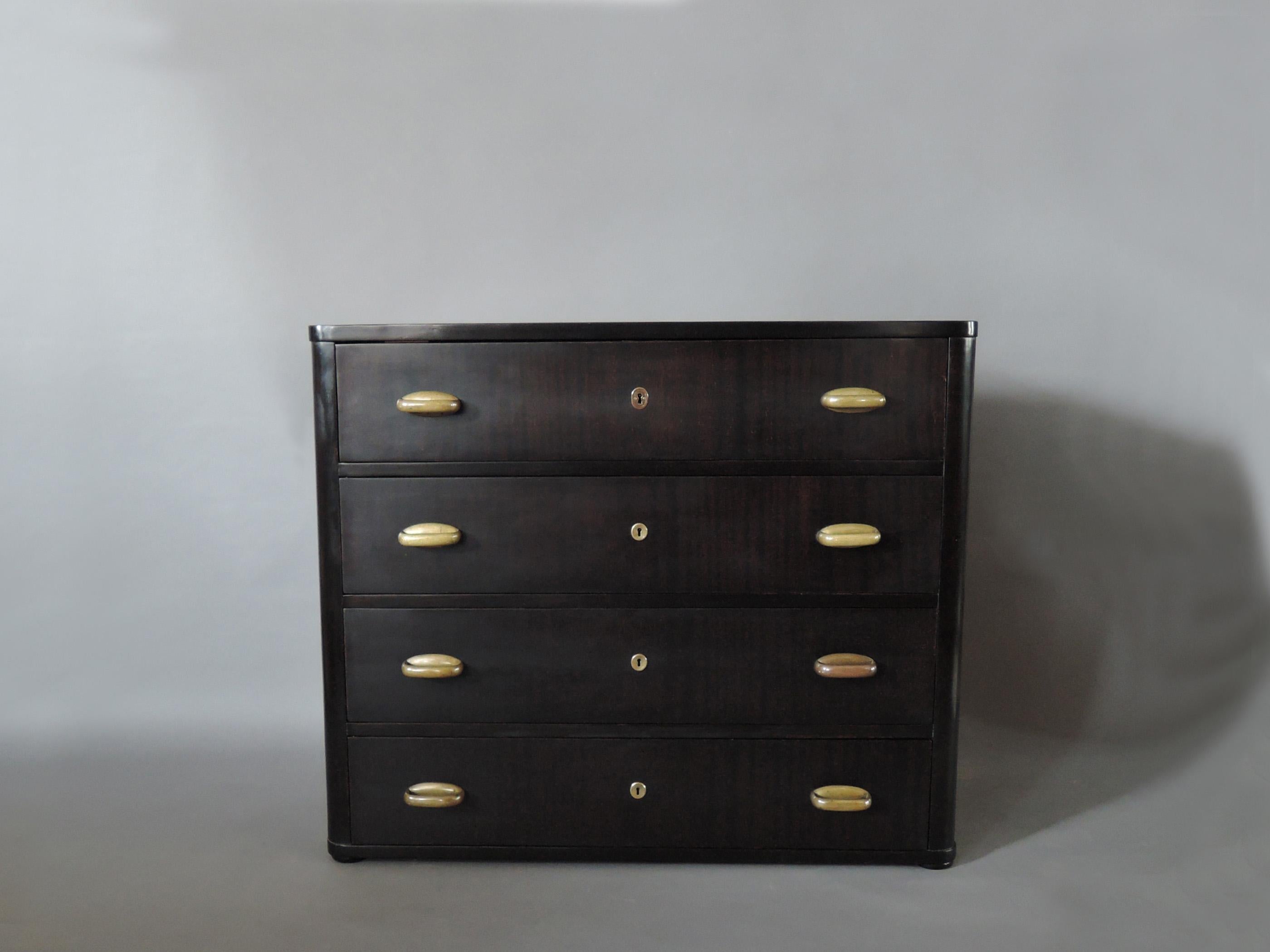 A fine Austrian Art Nouveau 4-drawer commode in darkened mahogany with patinated bronze handles and keyholes.

 