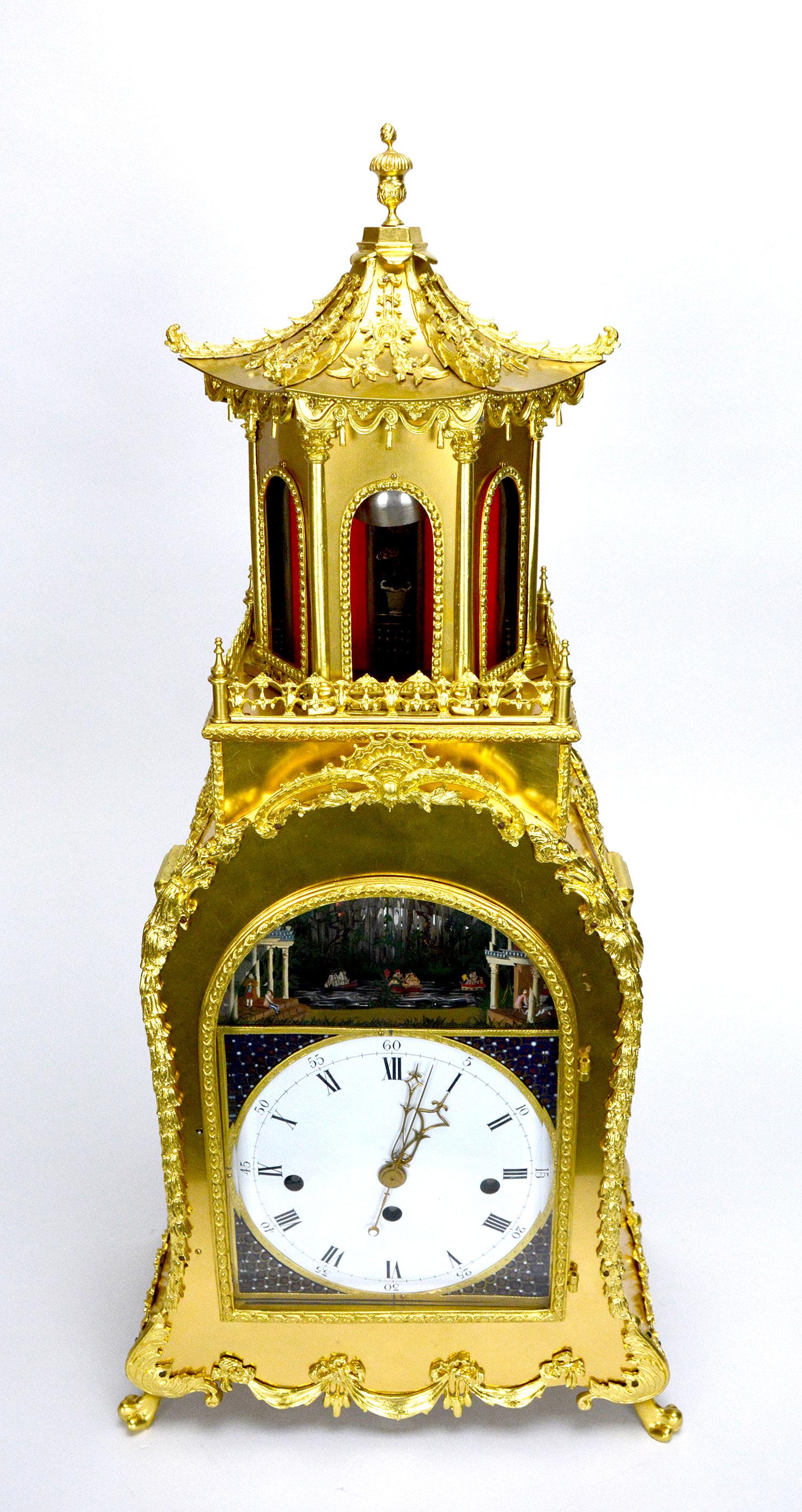 A large English George III Style Musical Automaton bracket clock. The gorgeous gilt bronze case is decorated with beautiful brass casting applications. There is a large pagoda on the top to make the appearance of this clock even more impressive. The