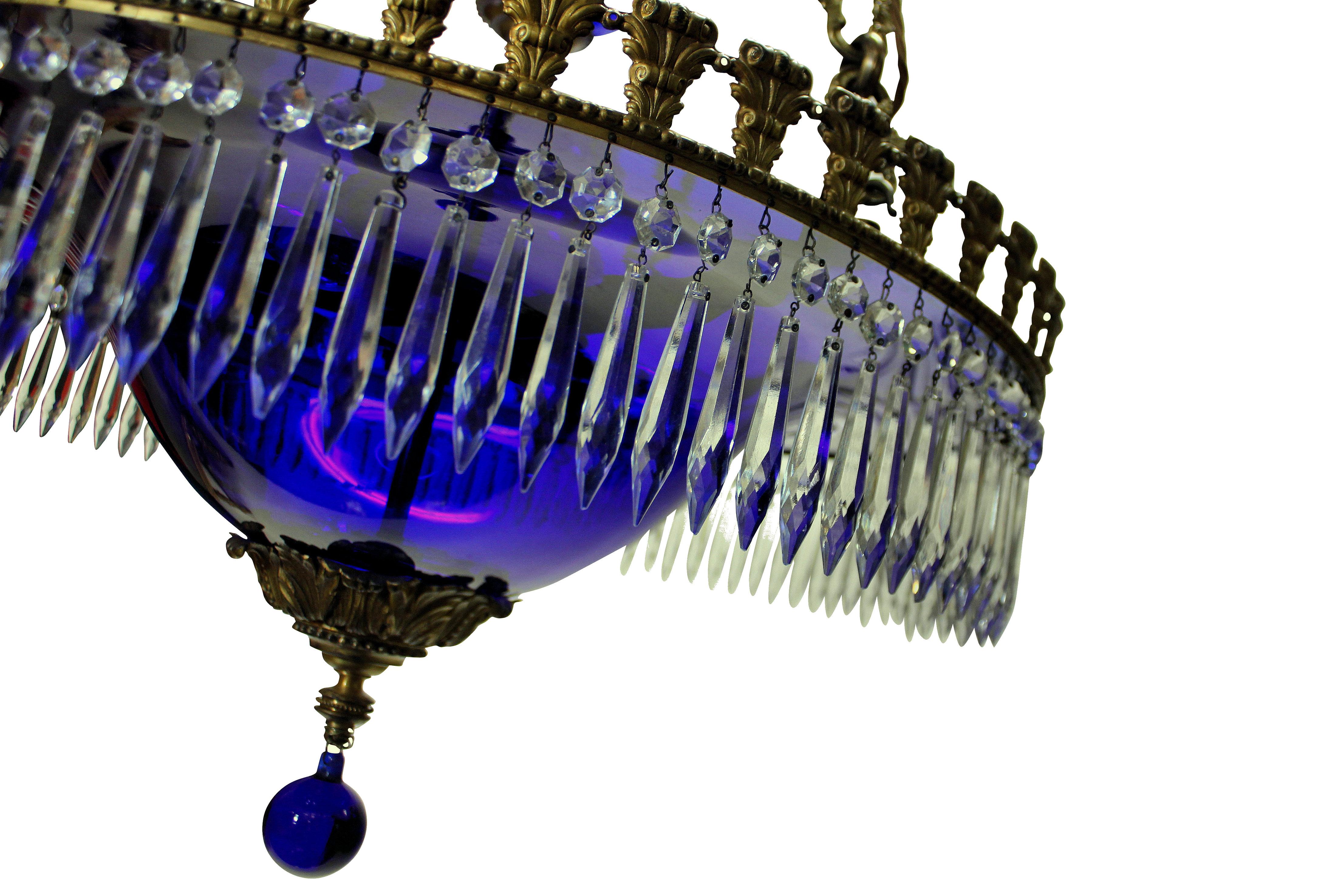 A fine Baltic neoclassical chandelier in blue glass, with gilt bronze frame and hung throughout with cut glass pendants.