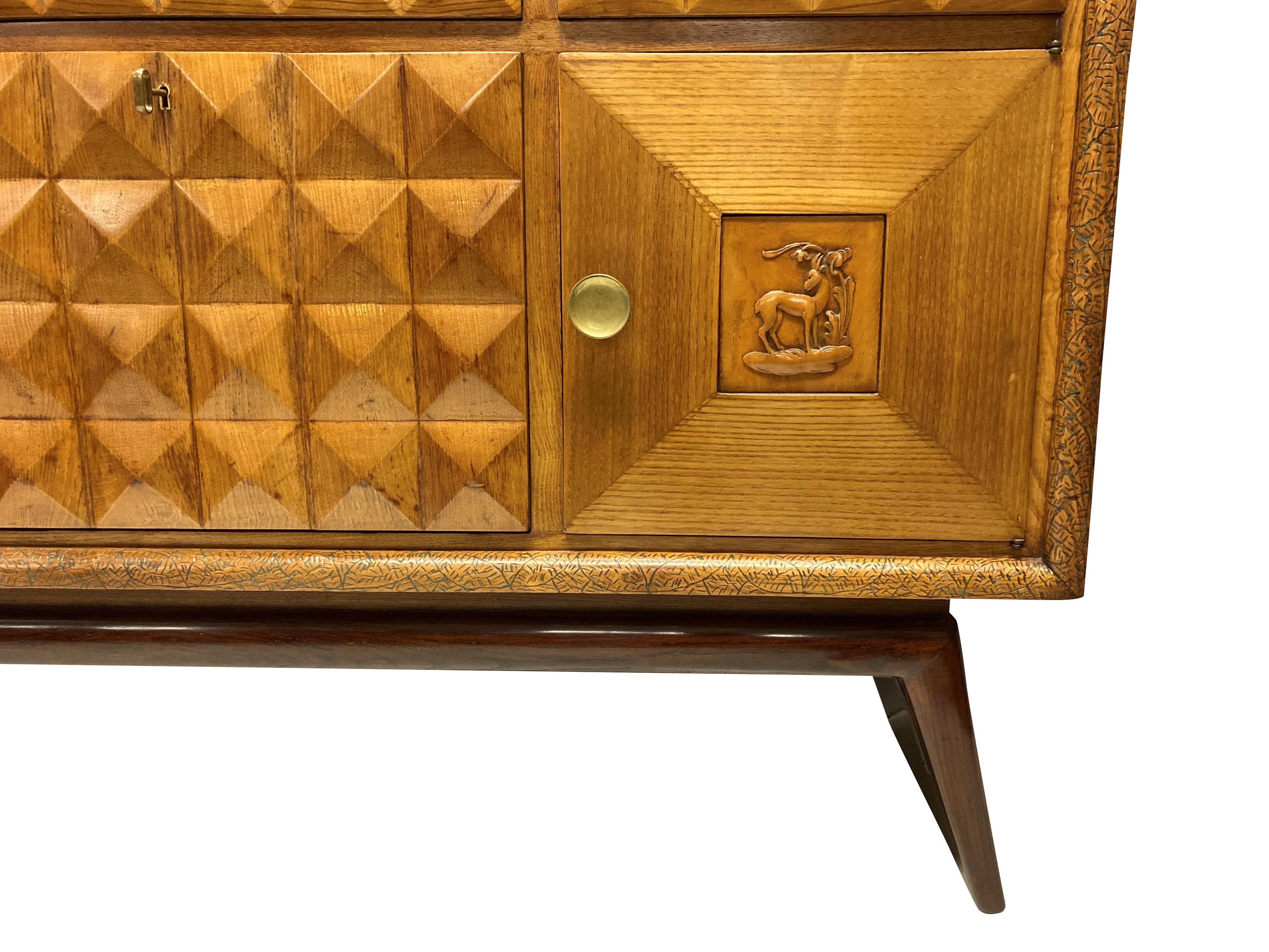A fine Italian bar credenza by Pier Luigi Colli. In oak, elm and lemon wood, comprising a central fall front bar cabinet, with cupboards and drawers. It has wonderful texture, with a diamond pattern throughout and a faux ivory decorative rail to the