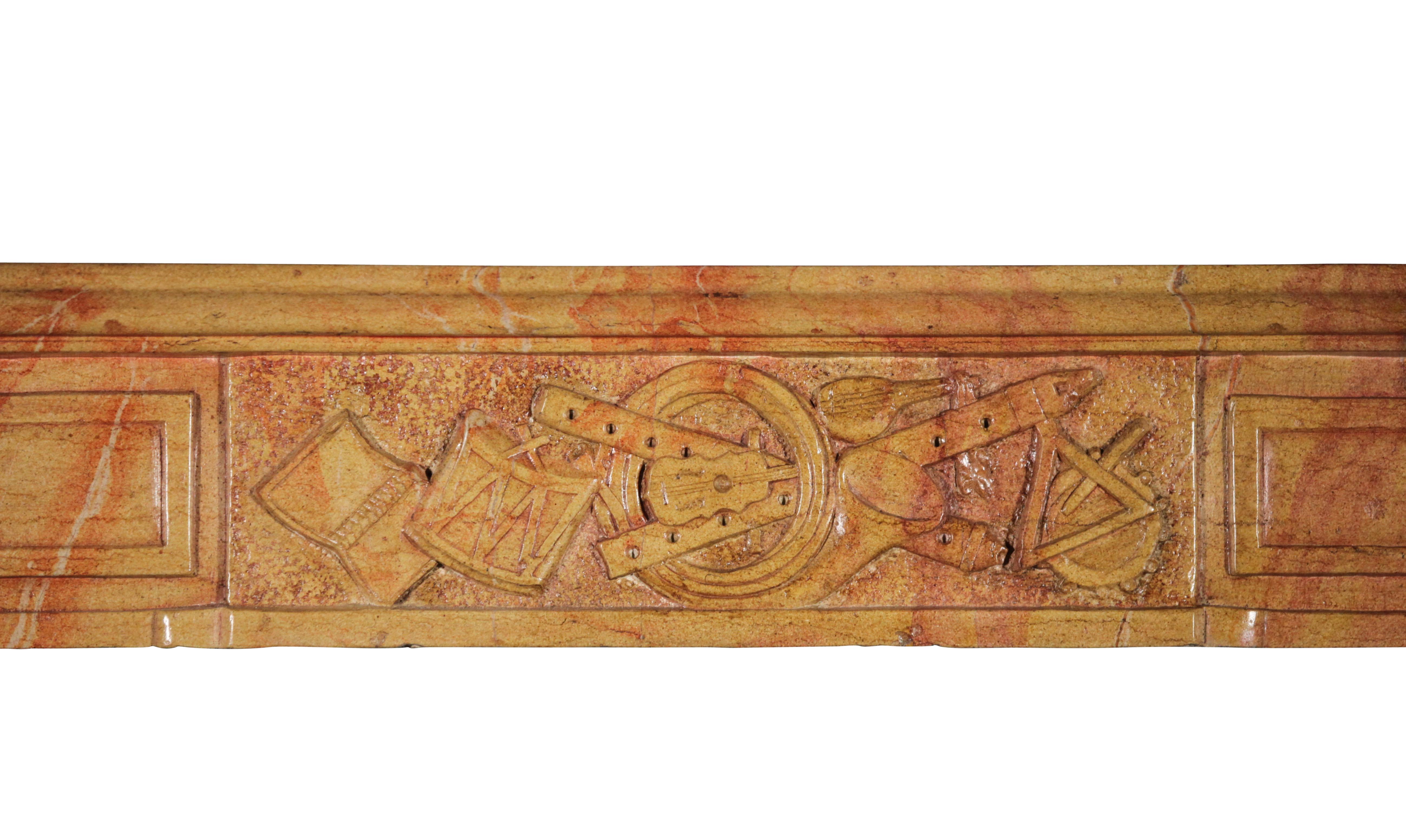 This fine European antique fireplace mantel is from the burgundy region near the Corton village. The bicolor of this marble hard stone is typical that village in the middle of the vineyards. The details on the front are showing music instruments.