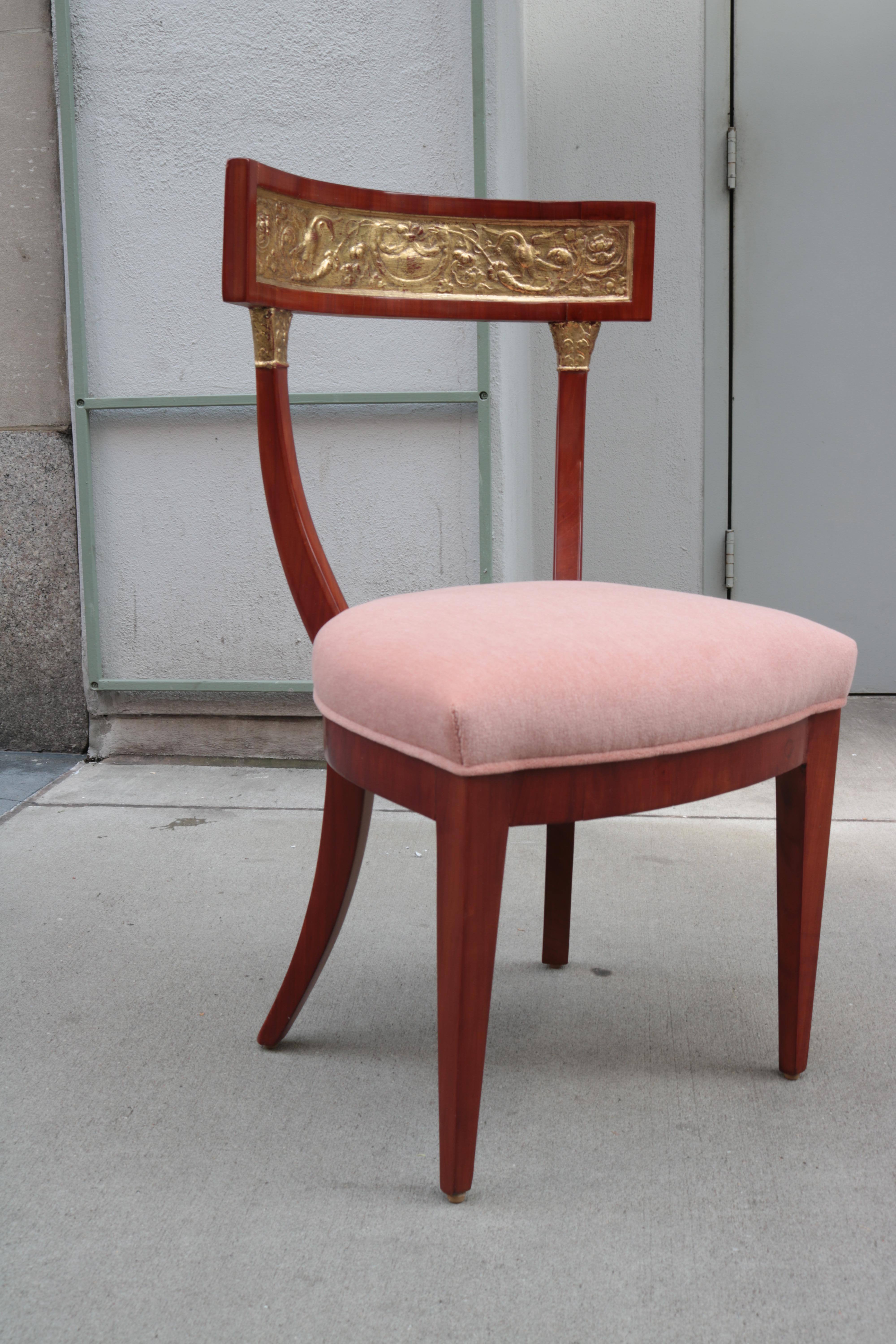 A fine early Biedermeier side chair.
Cherrywood with carved giltwood back rest.
 