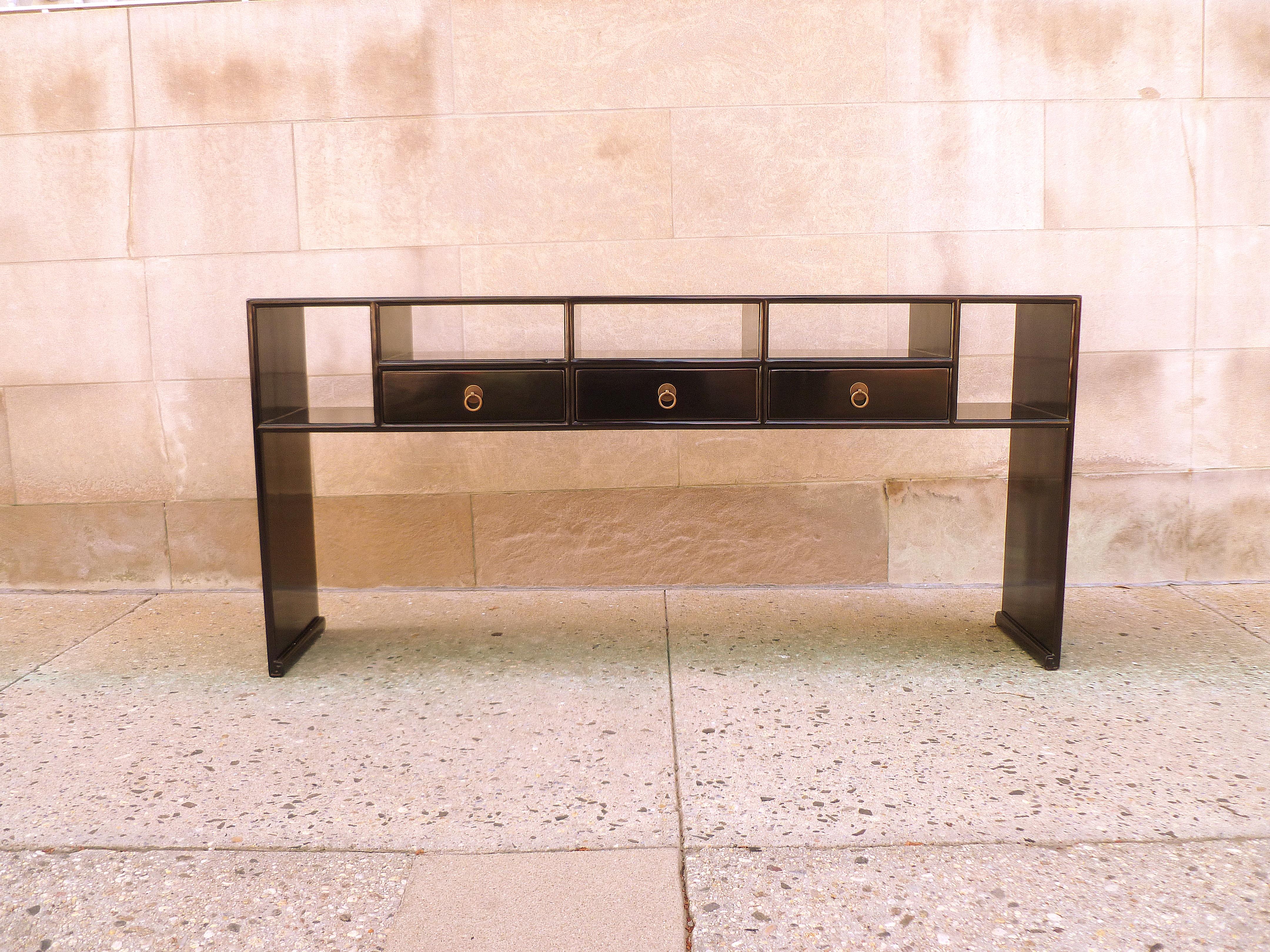 Fine black lacquer console table with drawers, shelves and waterfall legs. Very simple and elegant, Fine quality. Beautiful color and form. We carry Fine quality furniture with elegant finished and has been appeared many times in 