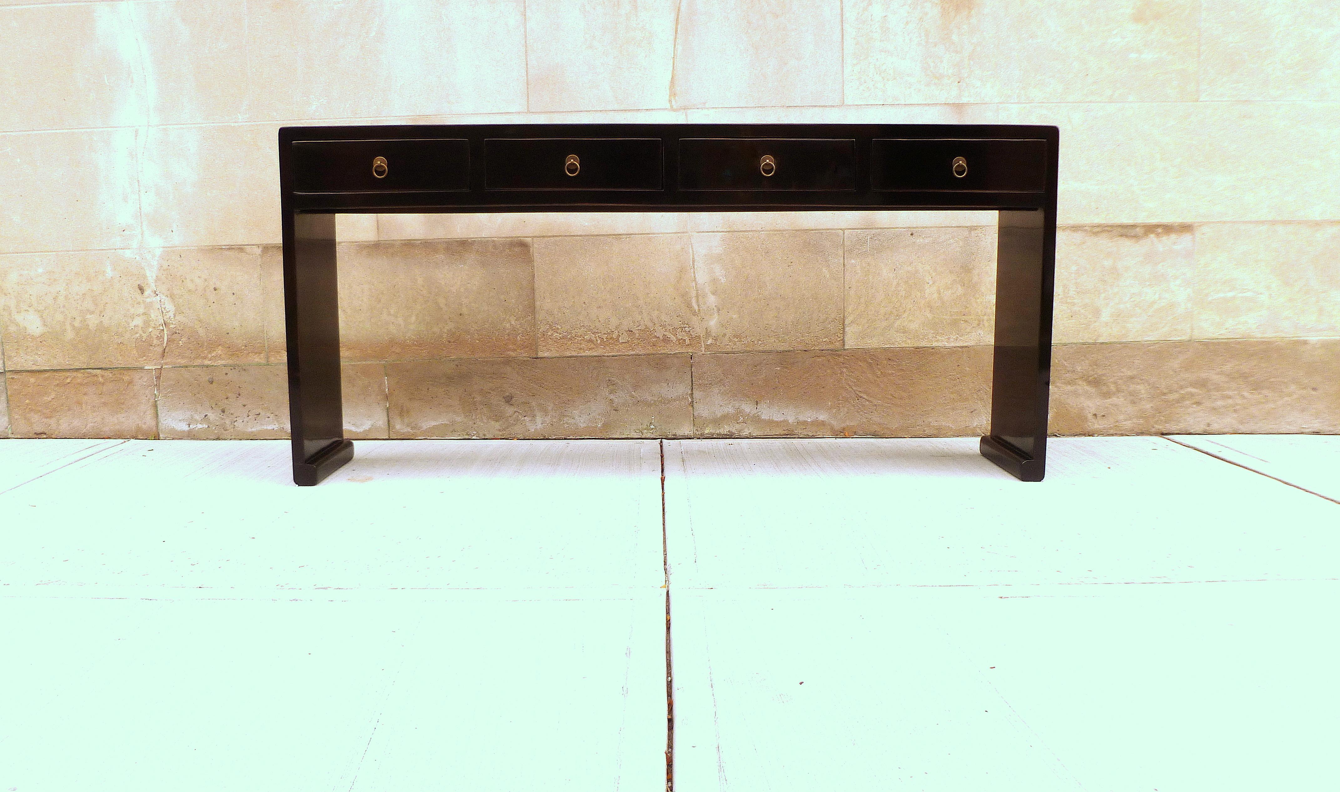 Fine black lacquer console table with four drawers, waterfall legs, brass fitting, elegant and simple form, beautiful lines. We carry fine quality furniture with elegant finished and has been appeared many times in 