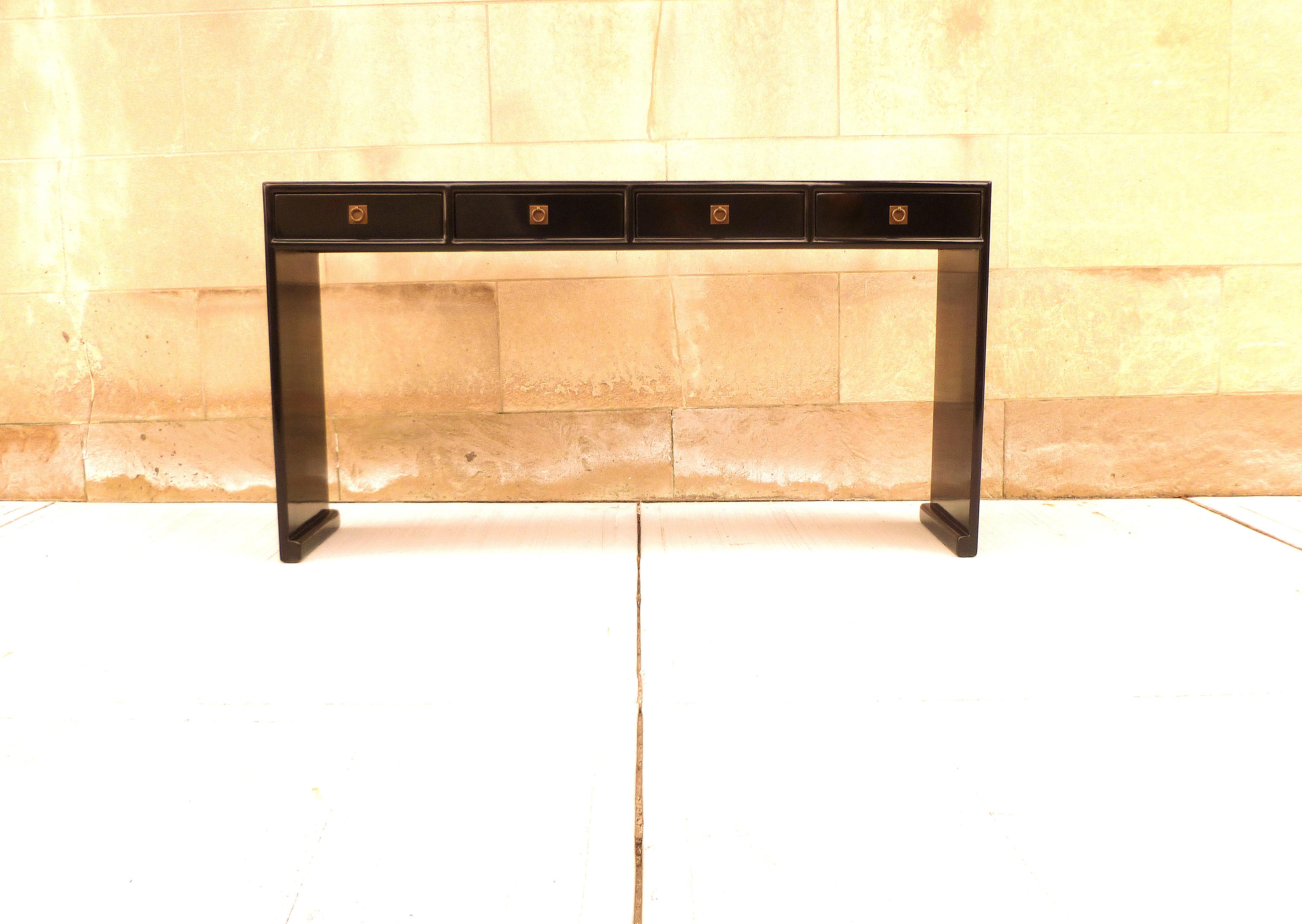 Fine black lacquer console table with four drawers, waterfall legs, brass fitting, elegant and simple form, beautiful lines. We carry Fine quality furniture with elegant finished and has been appeared many times in 