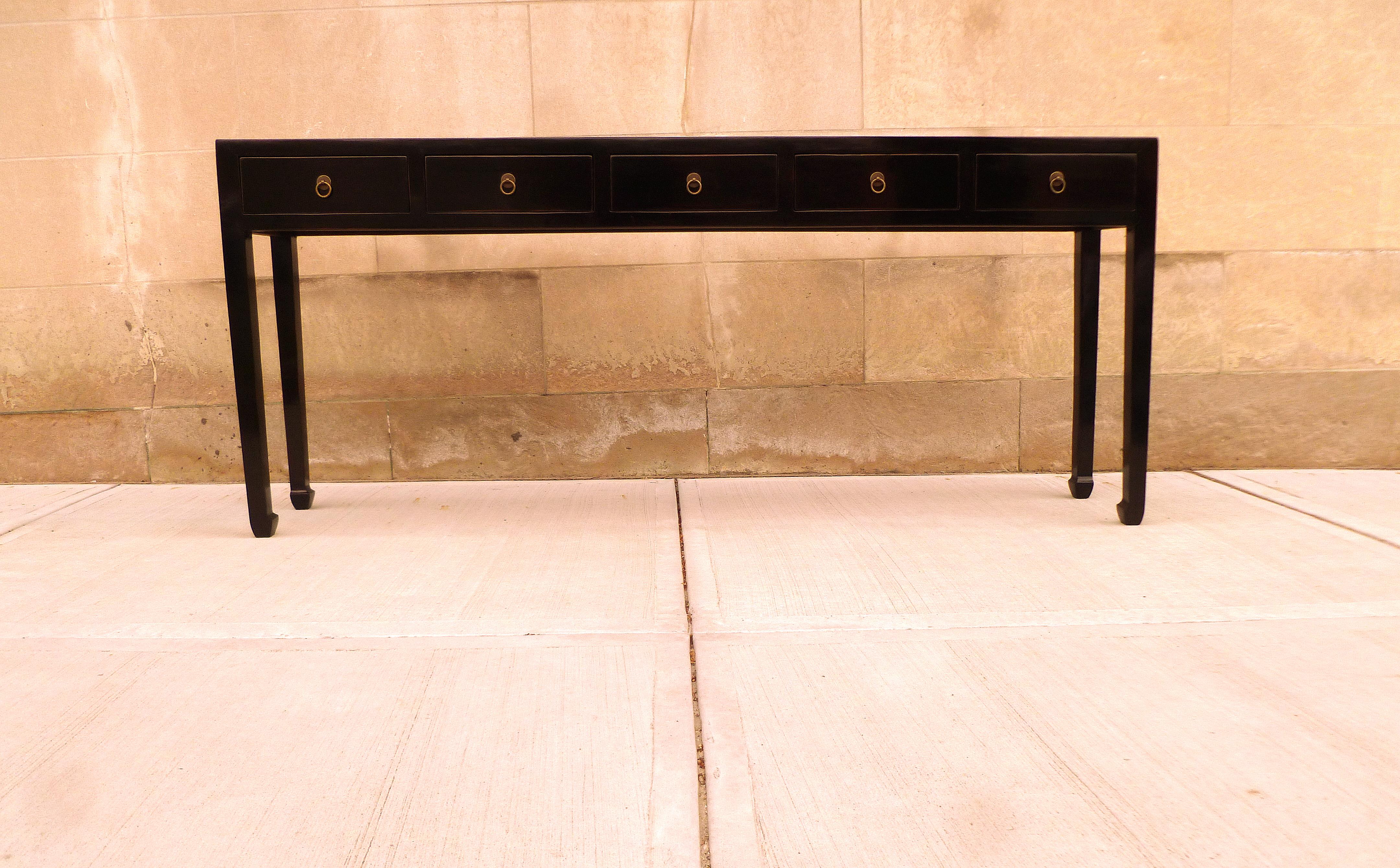 Elegant black lacquer console table with five drawers, brass fitting. Simple form and beautiful color. We carry fine quality furniture with elegant finished and has been appeared many times in 