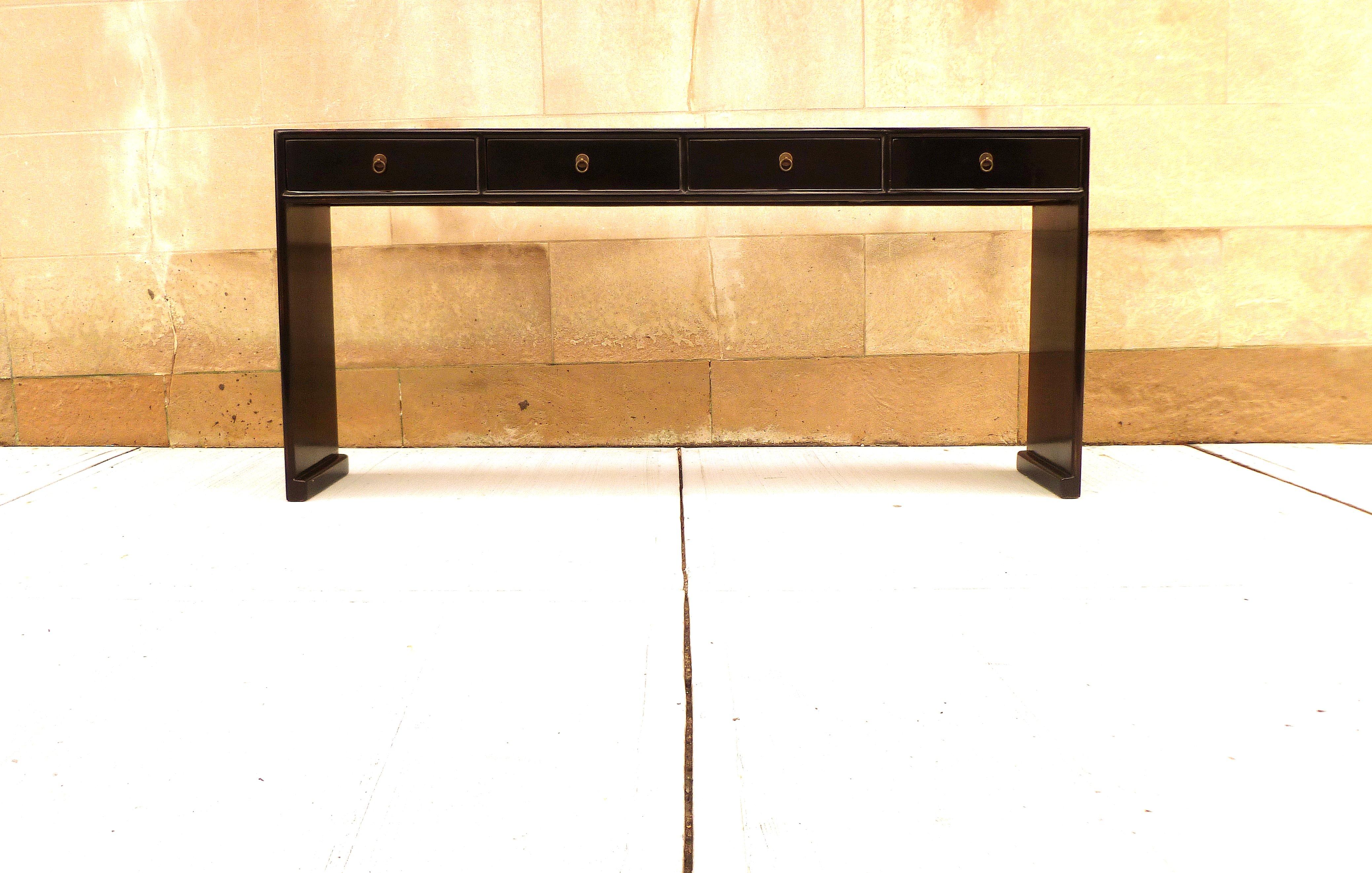 Fine black lacquer console table with four drawers, waterfall legs, brass fitting, elegant and simple form, beautiful lines. We carry fine quality furniture with elegant finished and has been appeared many times in 