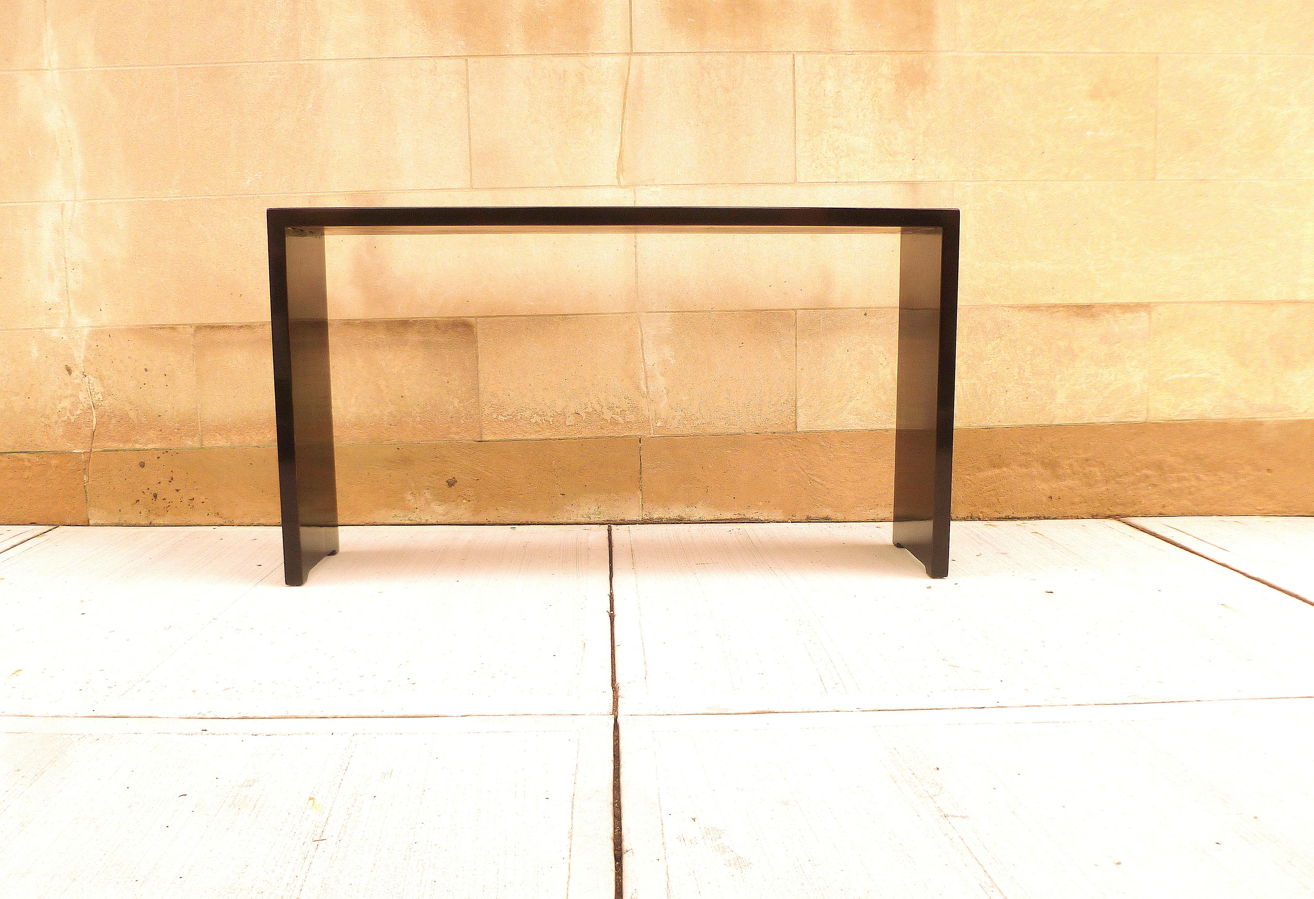 Simple black lacquer console table with waterfall legs, elegant color and lines. We carry fine quality furniture with elegant finished and has been appeared many times in 