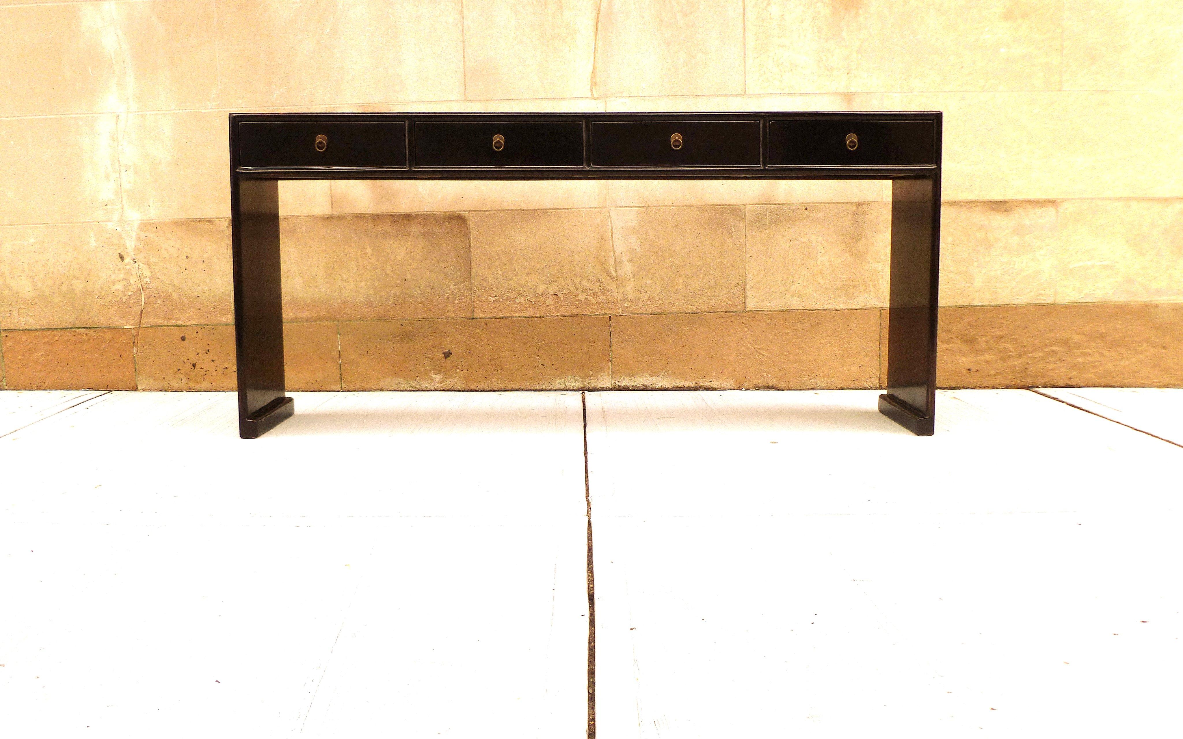 Fine black lacquer console table with four drawers, waterfall legs, brass fitting, elegant and simple form, beautiful lines. We carry fine quality furniture with elegant finished and has been appeared many times in 