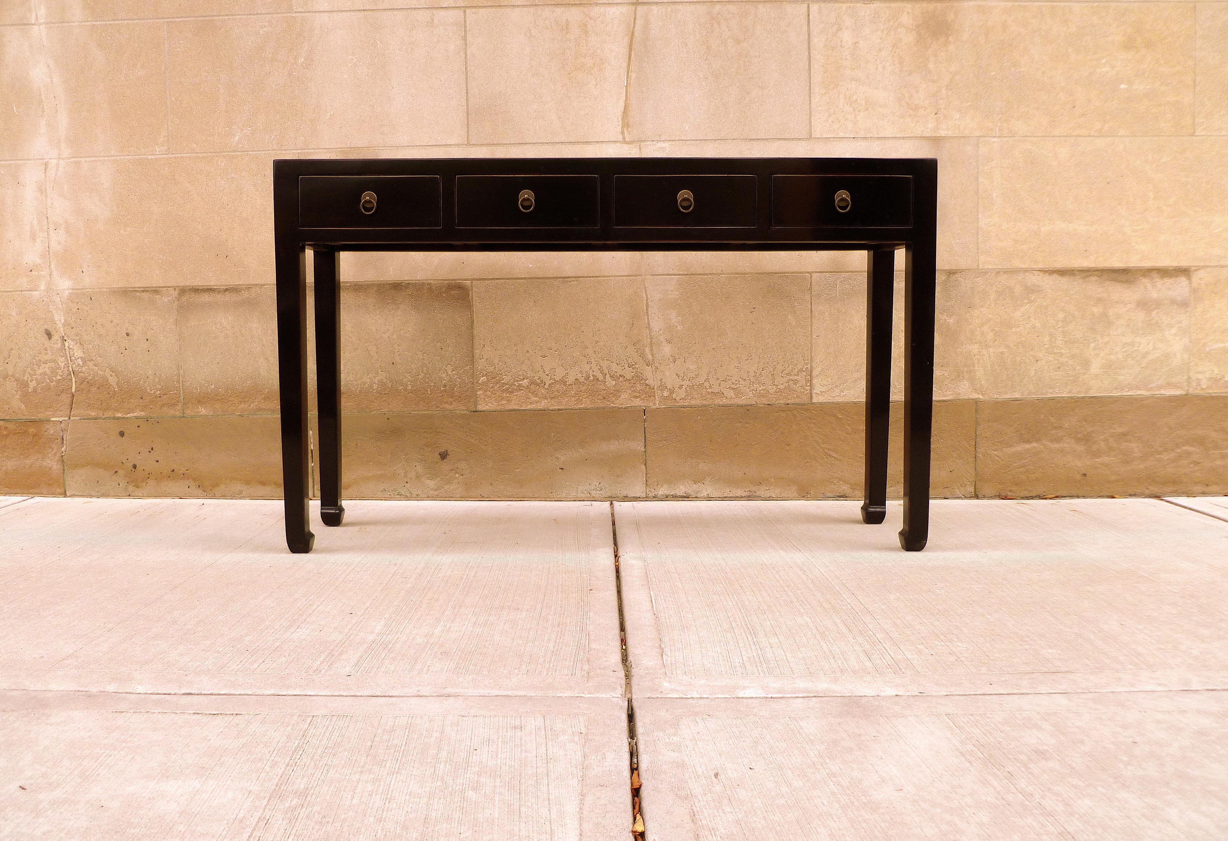 Elegant black lacquer console table with four drawers, brass fitting. Simple form and beautiful color. We carry fine quality furniture with elegant finished and has been appeared many times in 