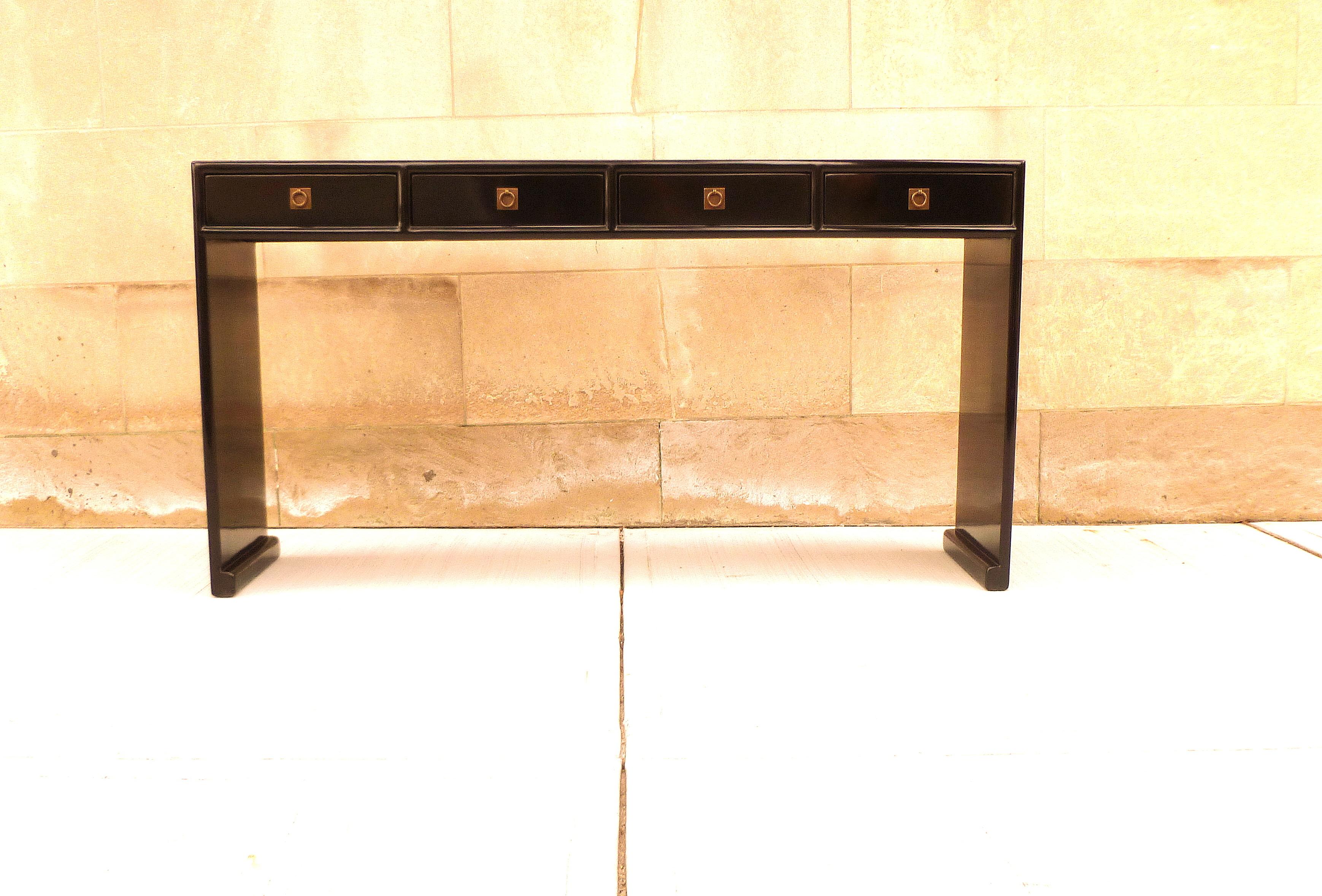 Fine black lacquer console table with four drawers, waterfall legs, brass fitting, elegant and simple form, beautiful lines. We carry fine quality furniture with elegant finished and has been appeared many times in 