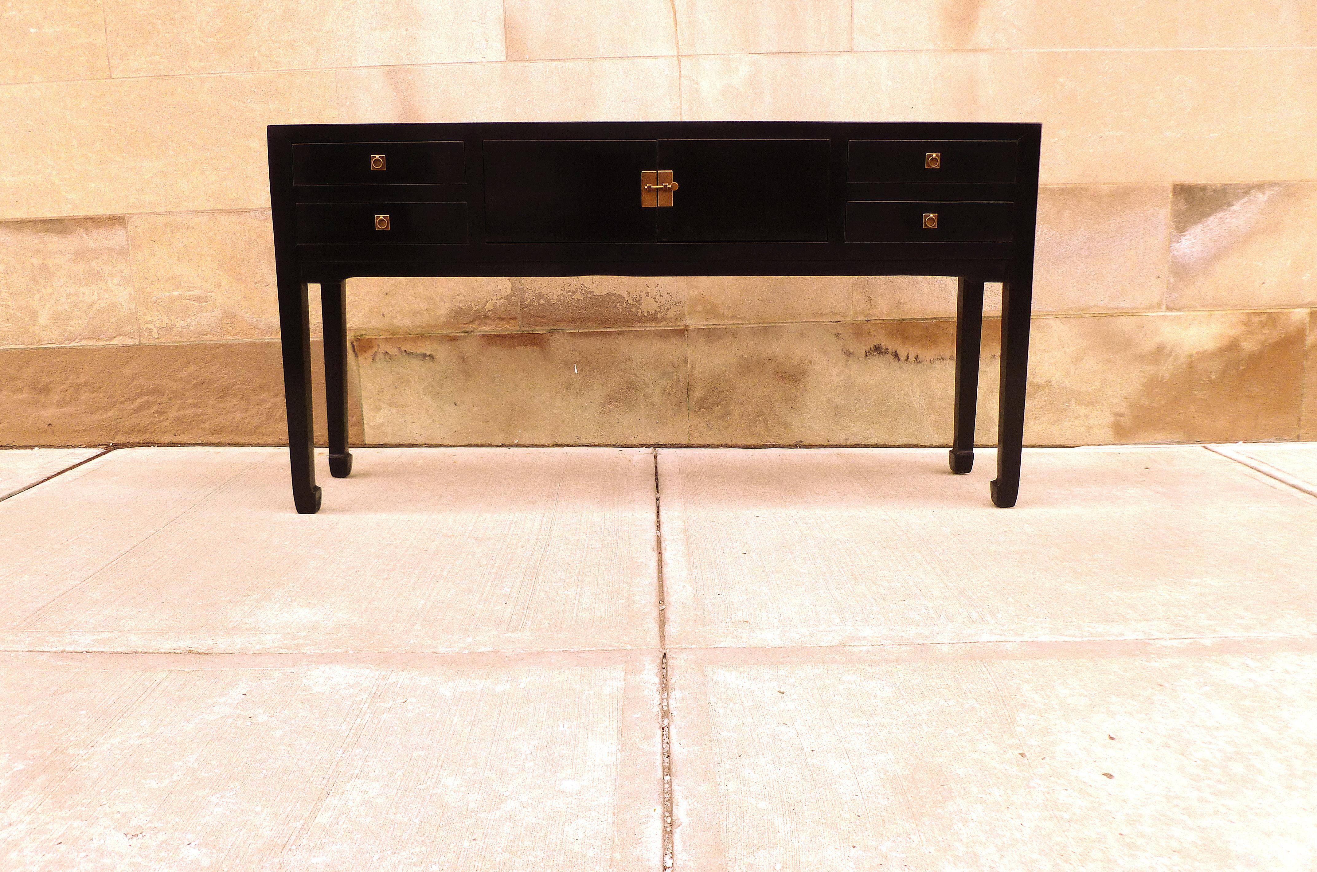 Fine black lacquer console table with four drawers and pair of doors. Very elegant and fine quality. Beautiful color and simple form. We carry fine quality furniture with elegant finished and has been appeared many times in 