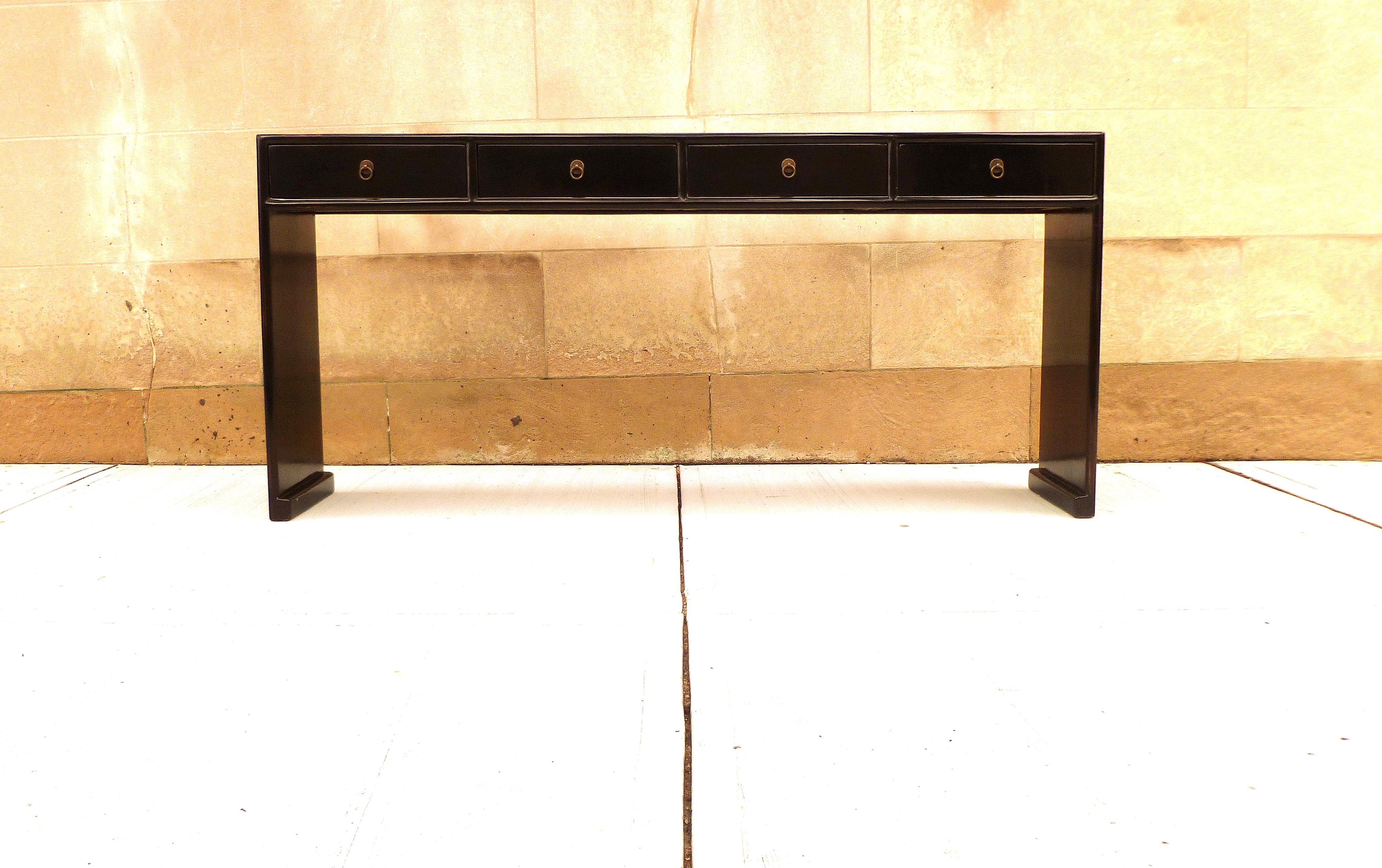 Fine black lacquer console table with four drawers, waterfall legs, brass fitting, elegant and simple form, beautiful lines. We carry fine quality furniture with elegant finished and has been appeared many times in 