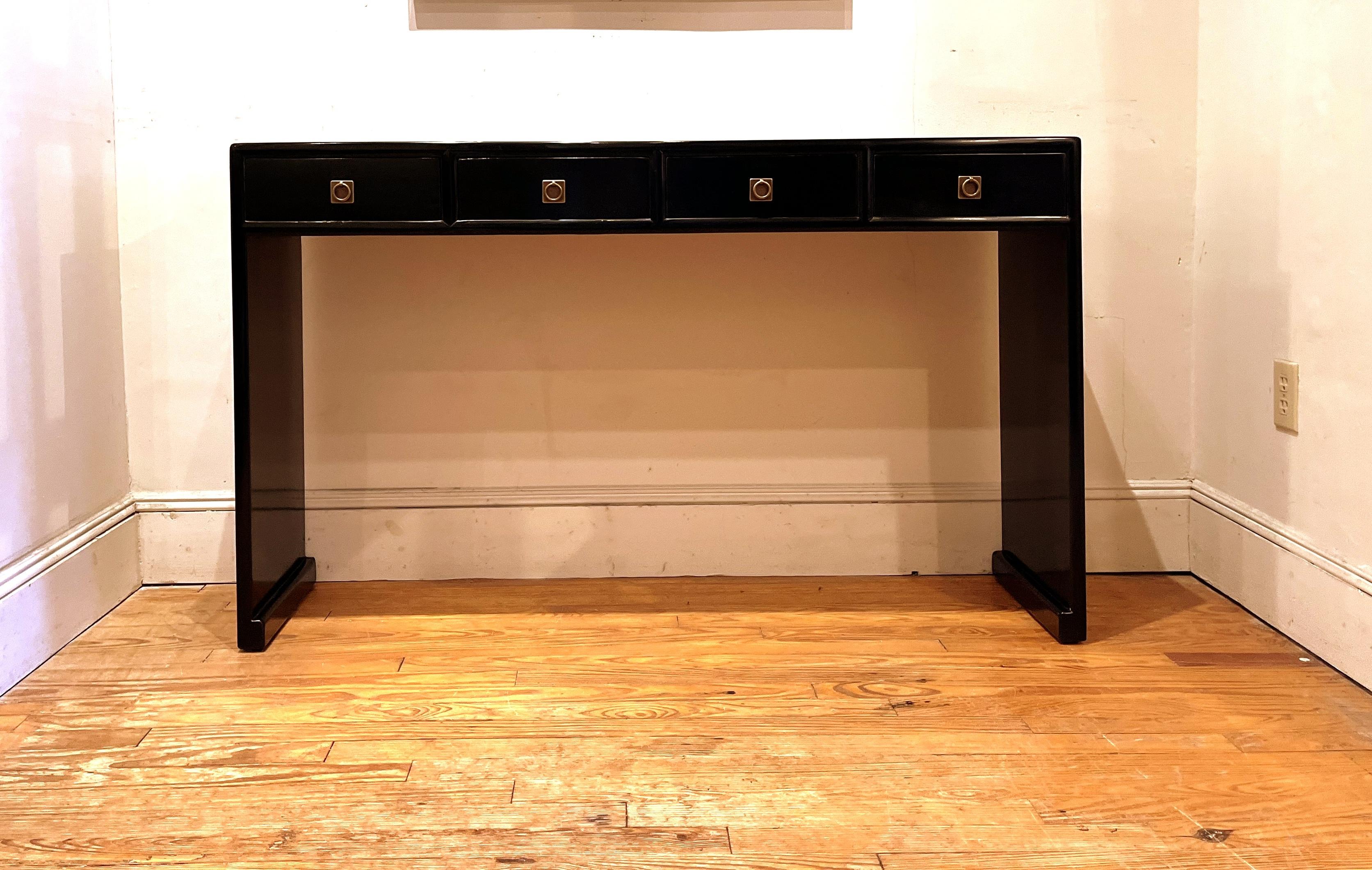 Fine black lacquer console table with four drawers, waterfall legs, brass fitting, elegant and simple form, beautiful lines. We carry fine quality furniture with elegant finished and has been appeared many times in 