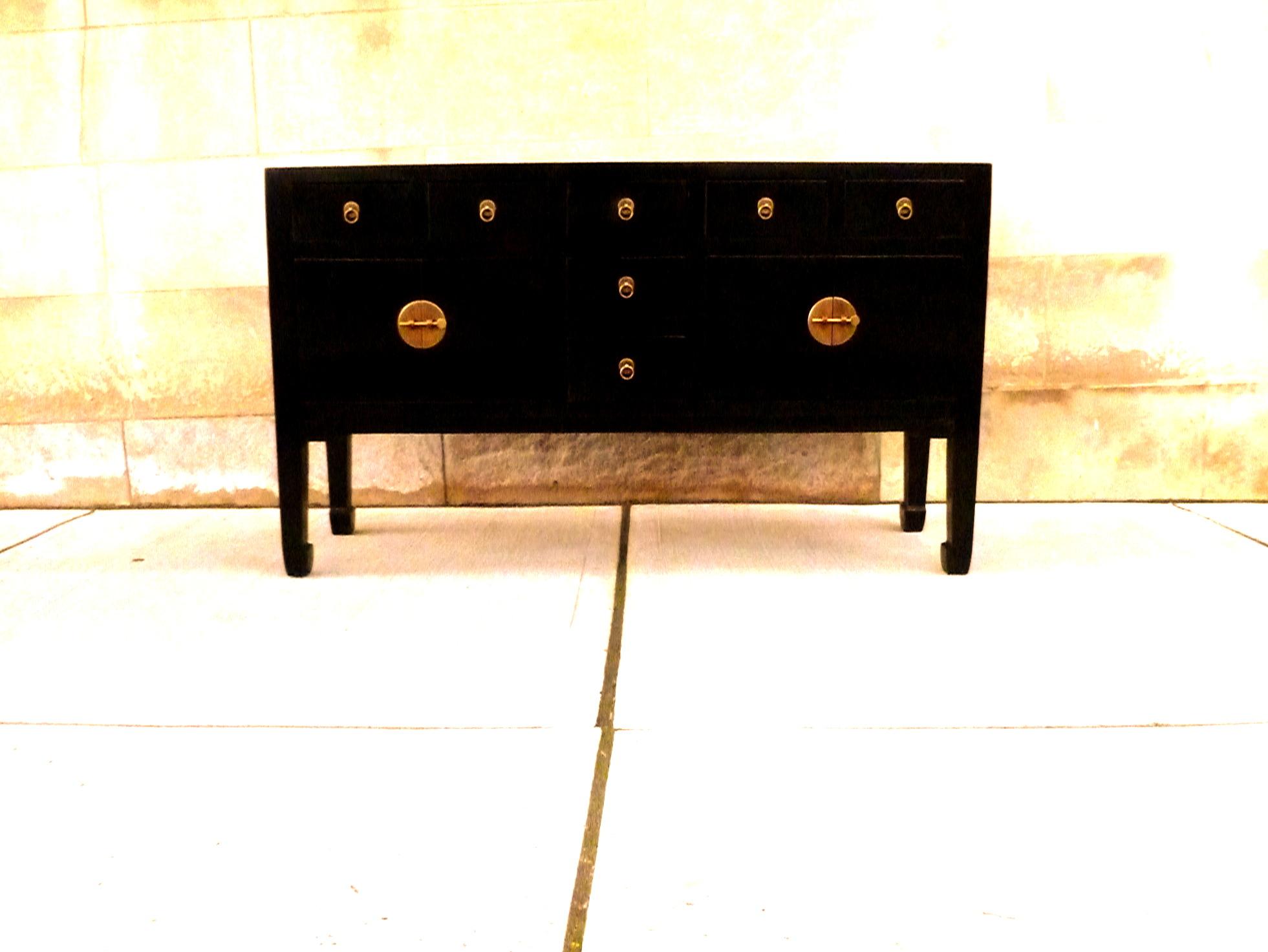 A refined and elegant black lacquer sideboard, framed top supported by square legs and joined by four drawers and two pairs of doors, brass fitting and ring pulls. We carry fine quality furniture with elegant finished and has been appeared many