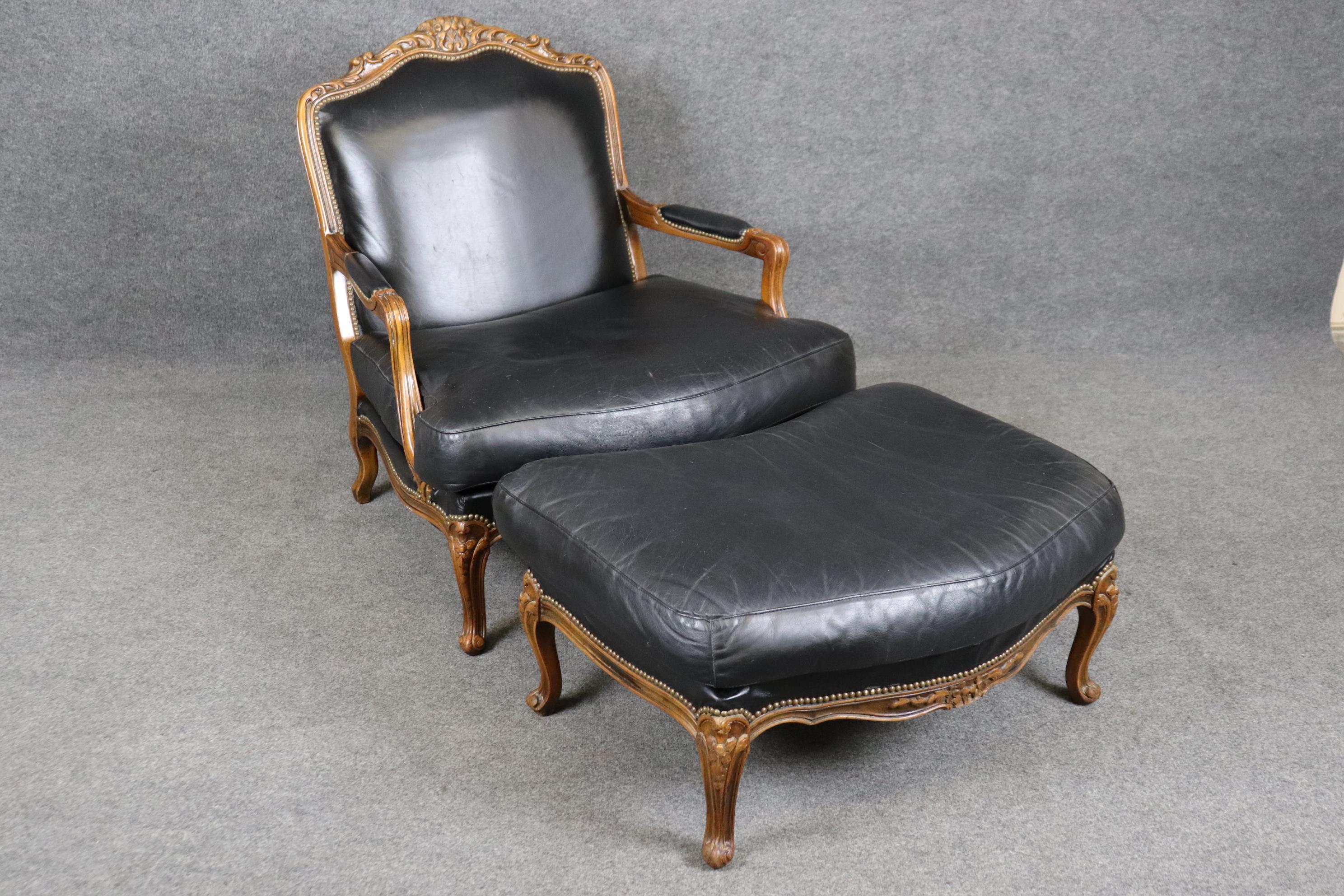 This is a gorgeous American-made French Louis XV style leather chair and ottoman in good condition. The leather is genuine top-grain leather and in good condition. Chair measures 37 tall x 35 wide x 38 deep and seat height is 18.5 and ottoman