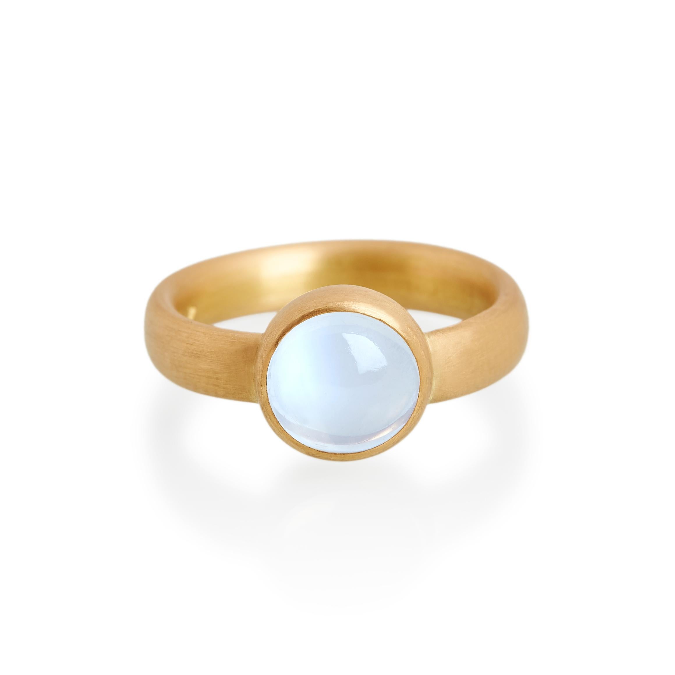 Cabochon cut fine blue moonstone ring. 
Ref: G19006

10mm round fine blue moonstone  
22ct gold (with platinum setting inlay)

Cadby & Co are a family business that specialise in reusing & up cycling old cut diamonds and fine gem stones. Deborah