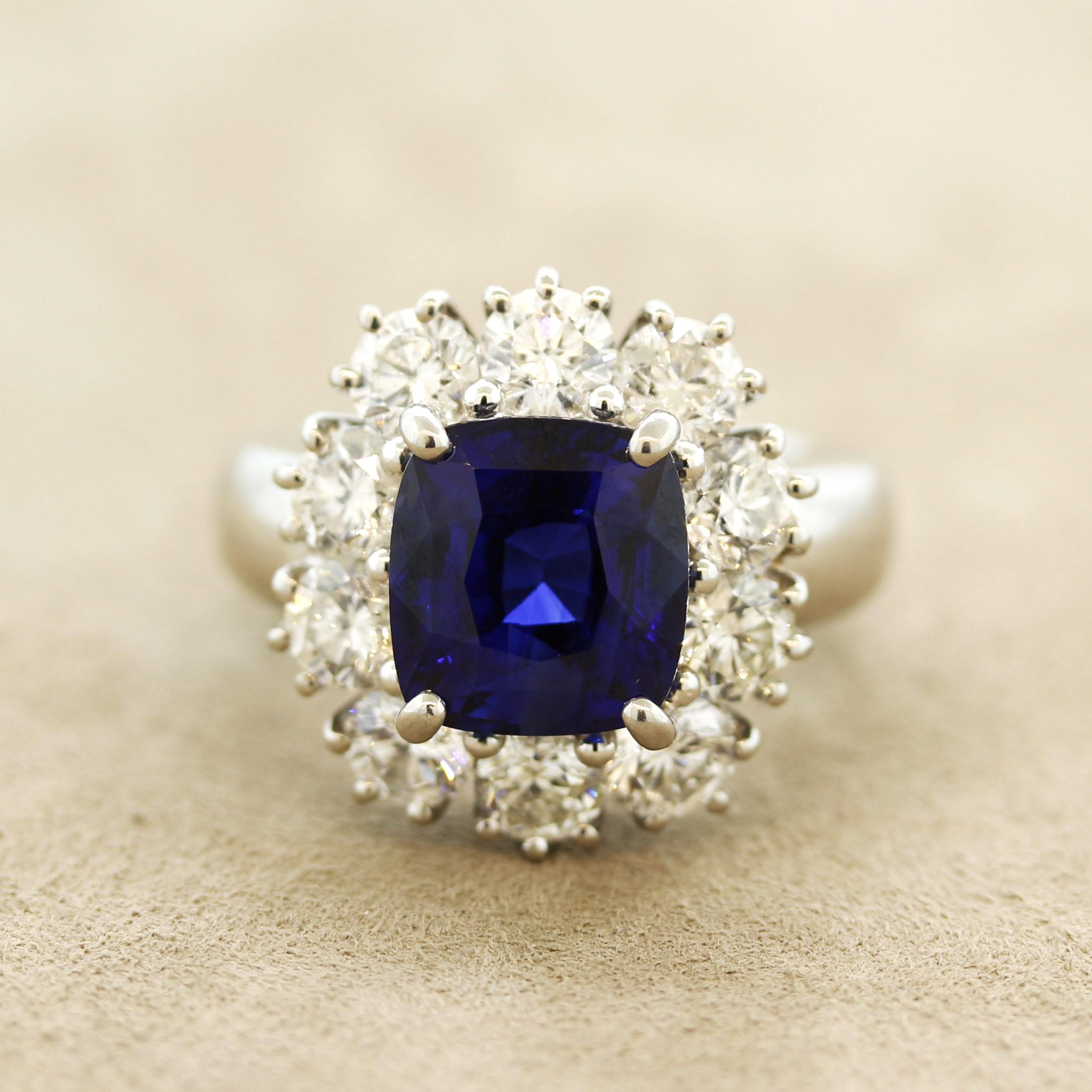 A rich royal blue sapphire with amazing color and clarity takes center stage of this platinum made ring! It weighs an impressive 5.88 carats and is certified by the AGL as natural. It is complemented by 3.13 carats of large round brilliant-cut