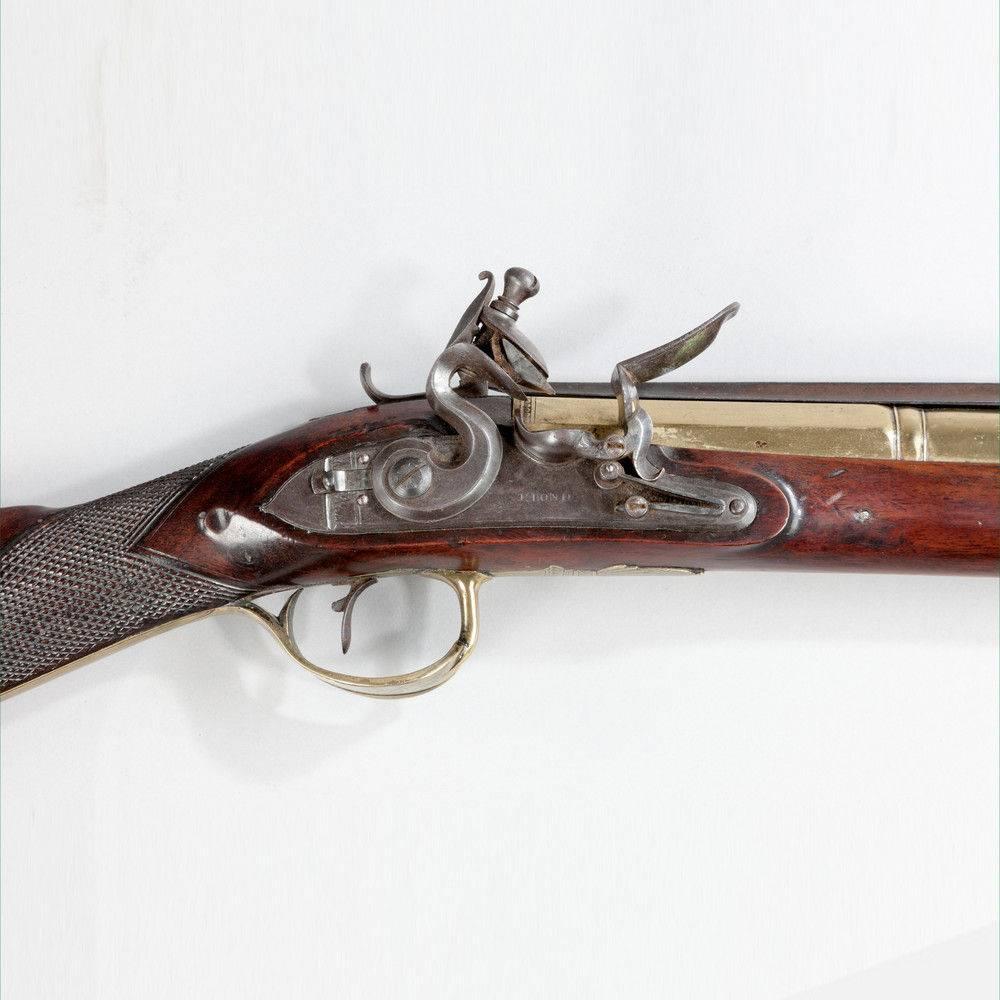 A fine Blunderbus by P Bond, with hinged bayonet and walnut stock, also with an unusual trigger guard and safety catch. Inscribed P.Bond, 45 Curn Hill, London, circa 1800. Lt 29