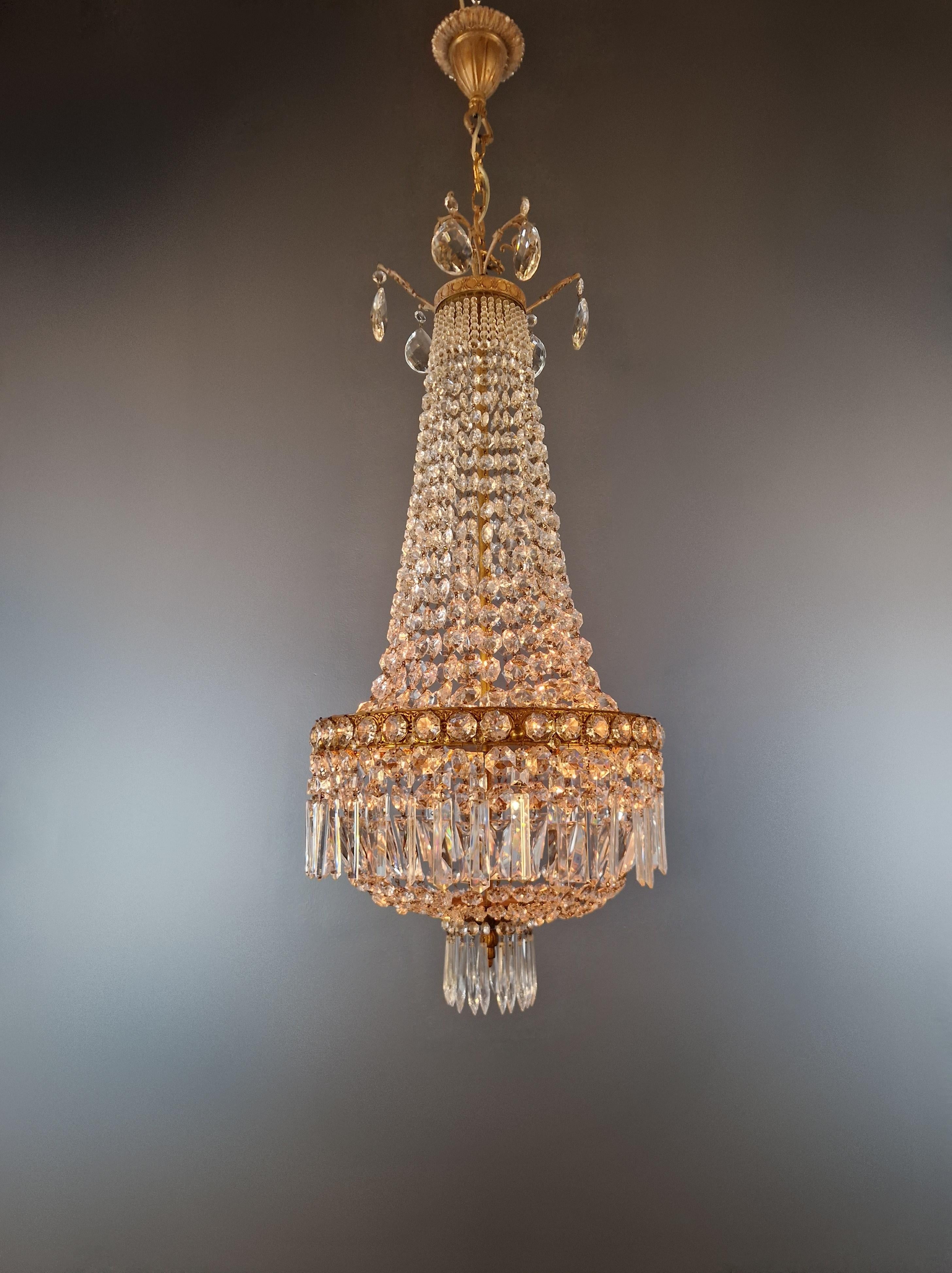 Introducing our exquisite antique chandelier - a masterpiece of elegance and style that will seamlessly complement any room with a touch of timeless beauty. With its stunning details and compact dimensions, this chandelier will add a touch of luxury