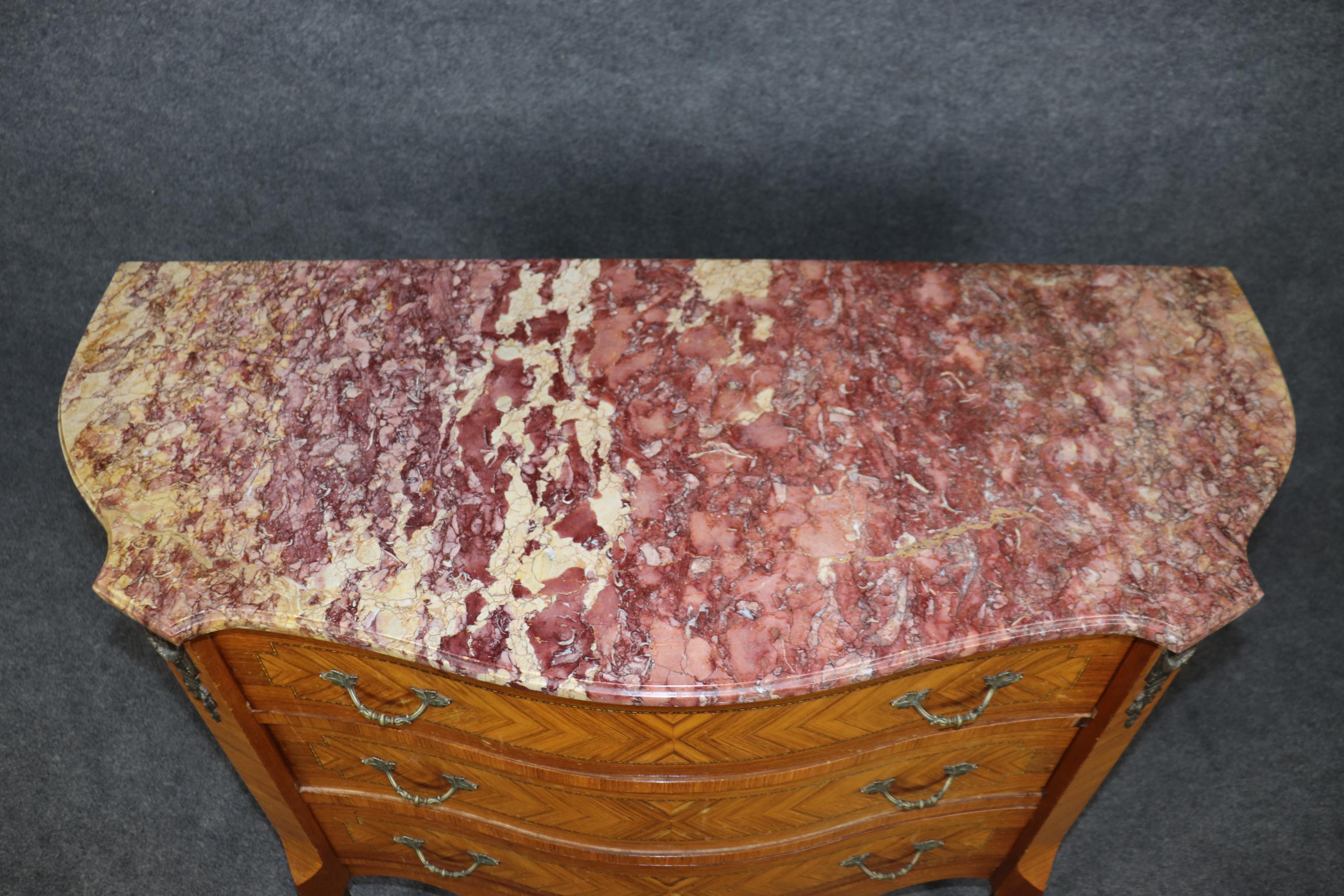 Si tratta di una superba commode con piano in marmo montato in bronzo e legno satinato, con marmo di breccia di colore tra il lavanda e il giallo. La cassa in legno di raso è in buone condizioni originali e presenta lievi segni di vecchie