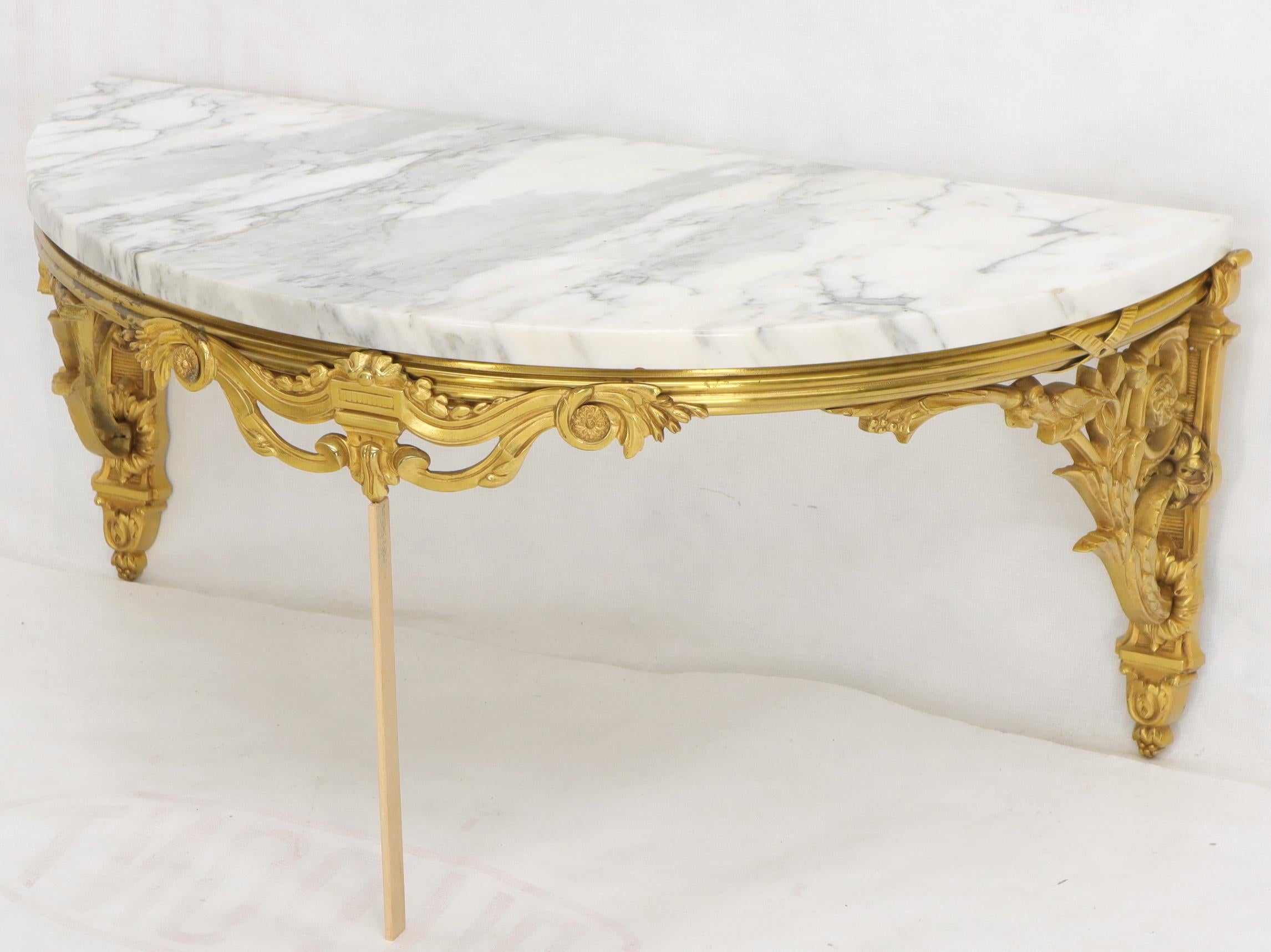 Heavy gold tone bronze marble top Demilune console hanging table.
