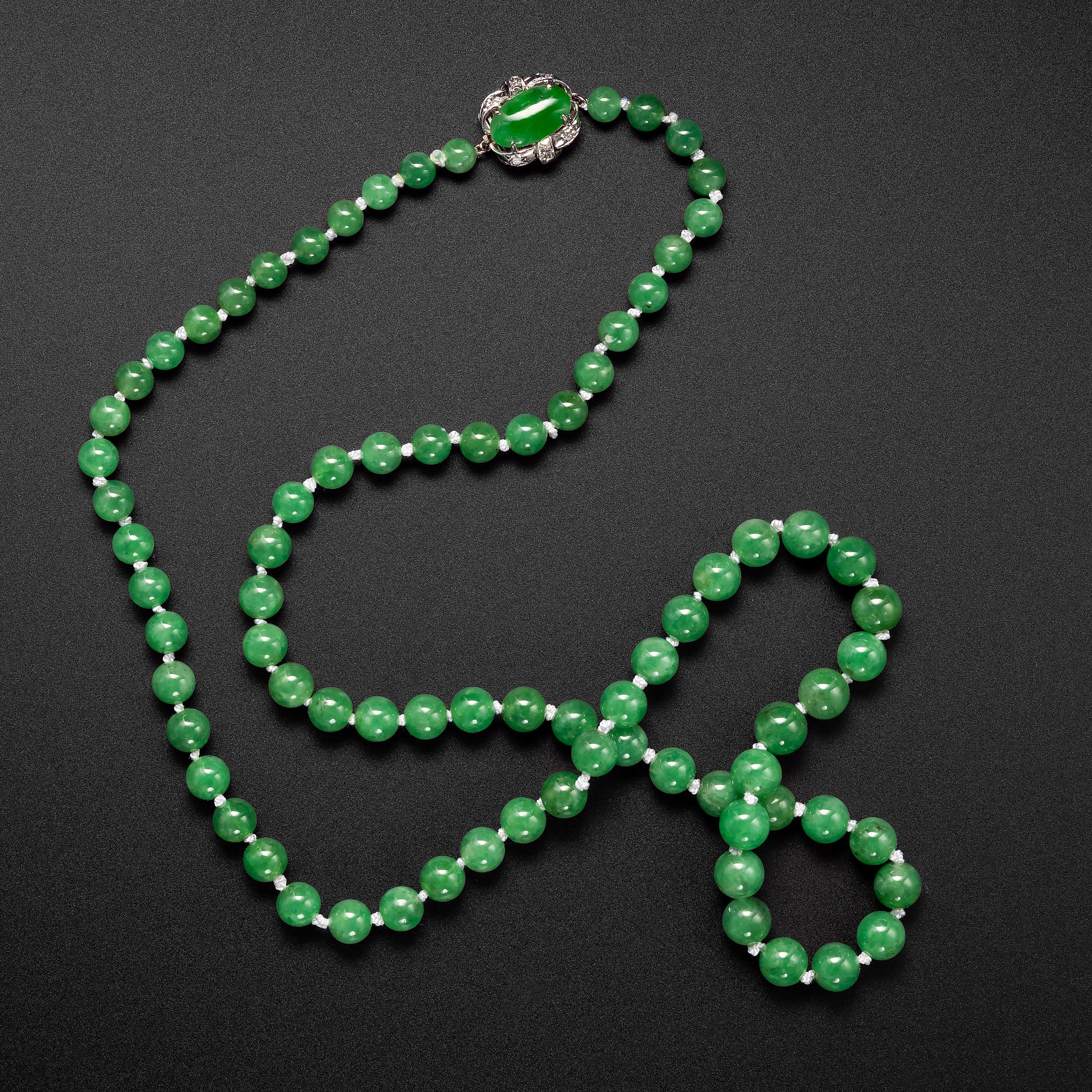 This vivid apple-green jade necklace is both exceedingly beautiful and exceedingly rare. Fine, untreated Burmese jadeite jade of this color, translucency, and evenness of tone is rare.  

Measuring 25