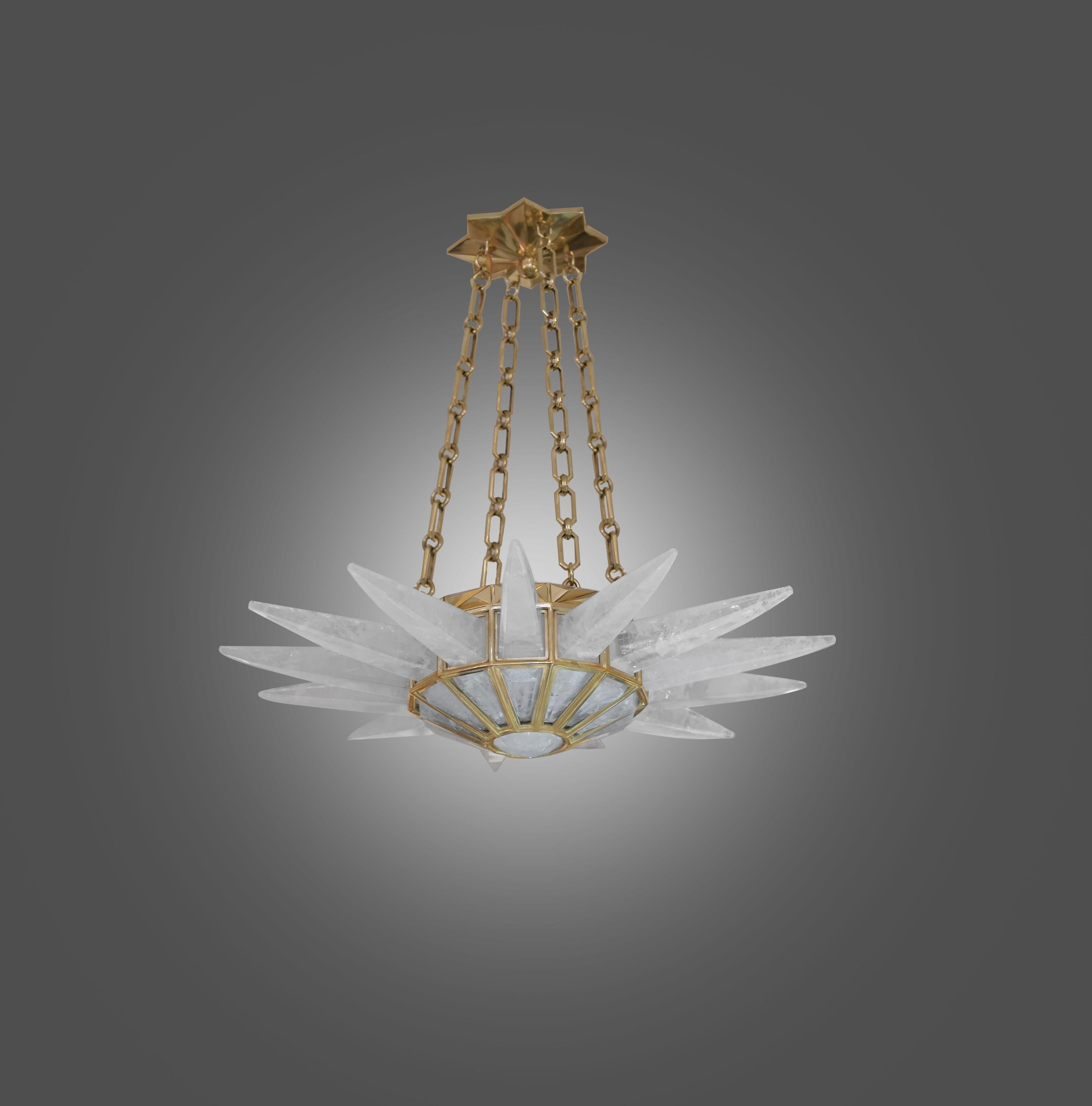A finely carved contemporary rock crystal quartz chandelier with polished brass finished frame. Created by Phoenix Gallery, NYC.
Height can be adjustable.
Available in nickel plating and antique brass finish.
Custom size upon request.
 