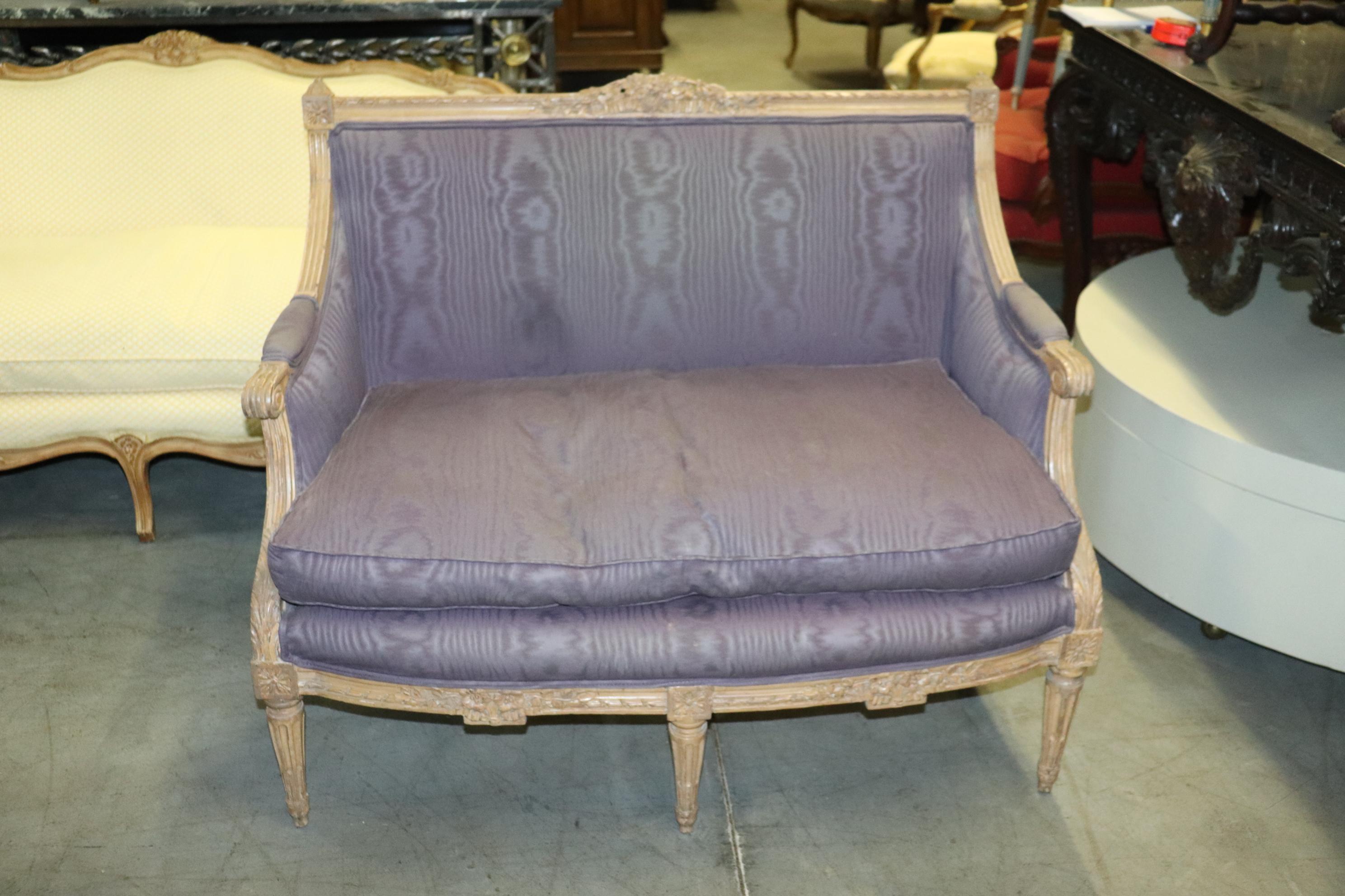 This is a rare size of settee, often called a marquis or smaller canape. The settee is in good original condition with incredible crisp carving and detail. The antique white painted finish has a great patina and the upholstery is in good condition