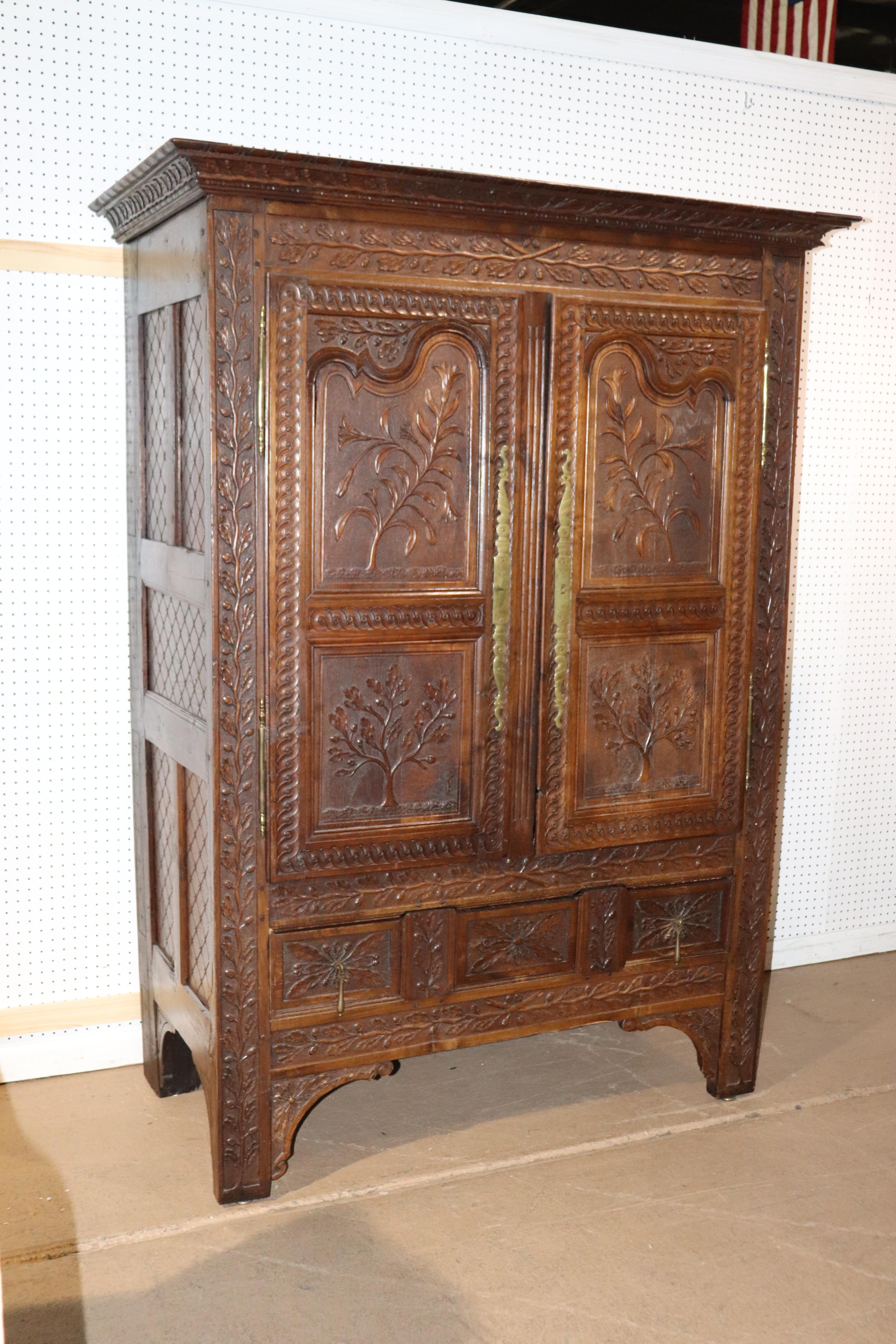This is a superbly carved French armoire from the 1780s that's been beautifully converted into a TV cabinet. The interior has a hold drilled into it for wiring and is lined in a beautiful paper. The cabinet has a single drawer and the bottom and