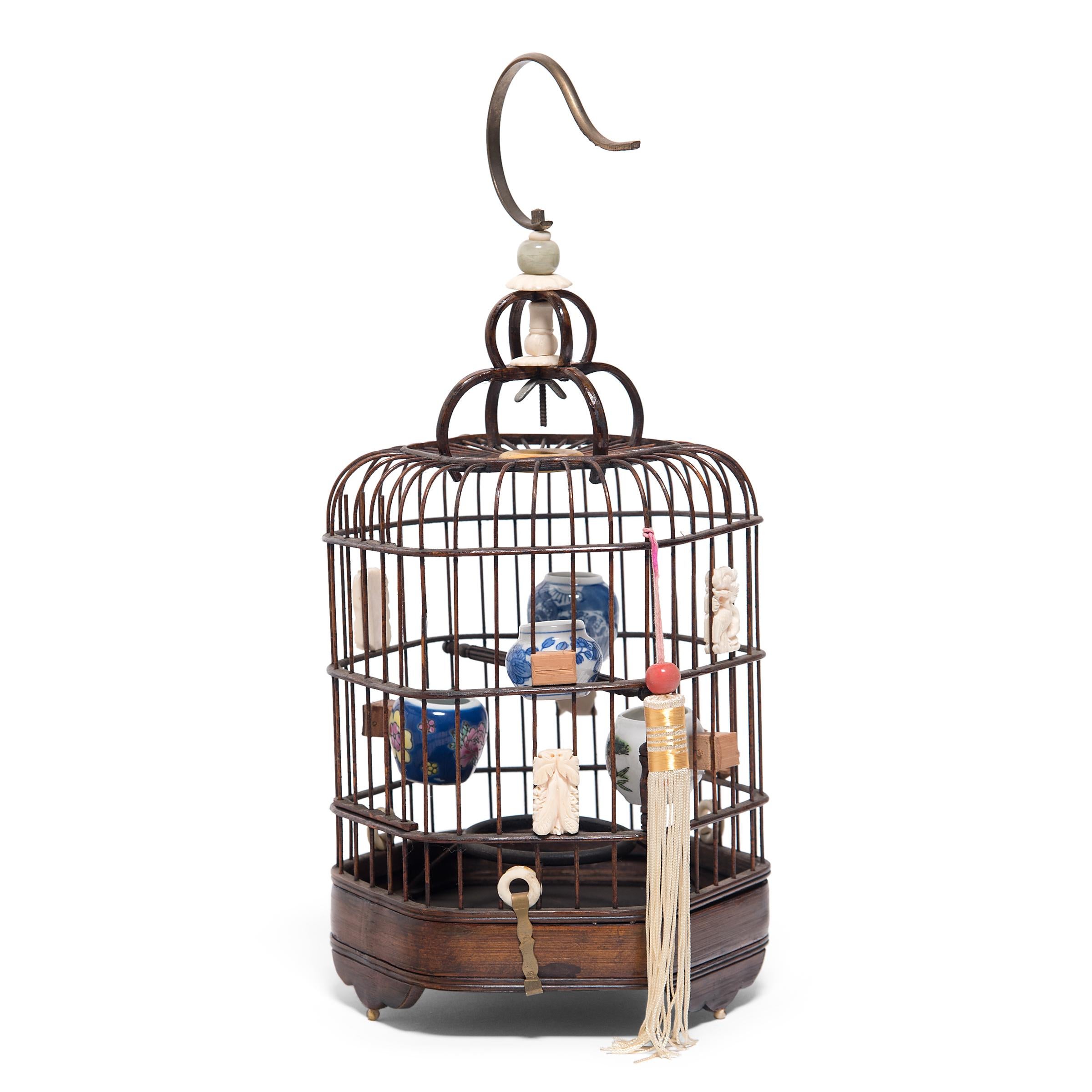 Perfectly proportioned and delightfully ornate, this wooden bird cage was once home to the pet of a Qing-dynasty aristocrat. Dated to the mid-19th century, the fine bird cage is carefully assembled from thin strips of wood and fitted with two