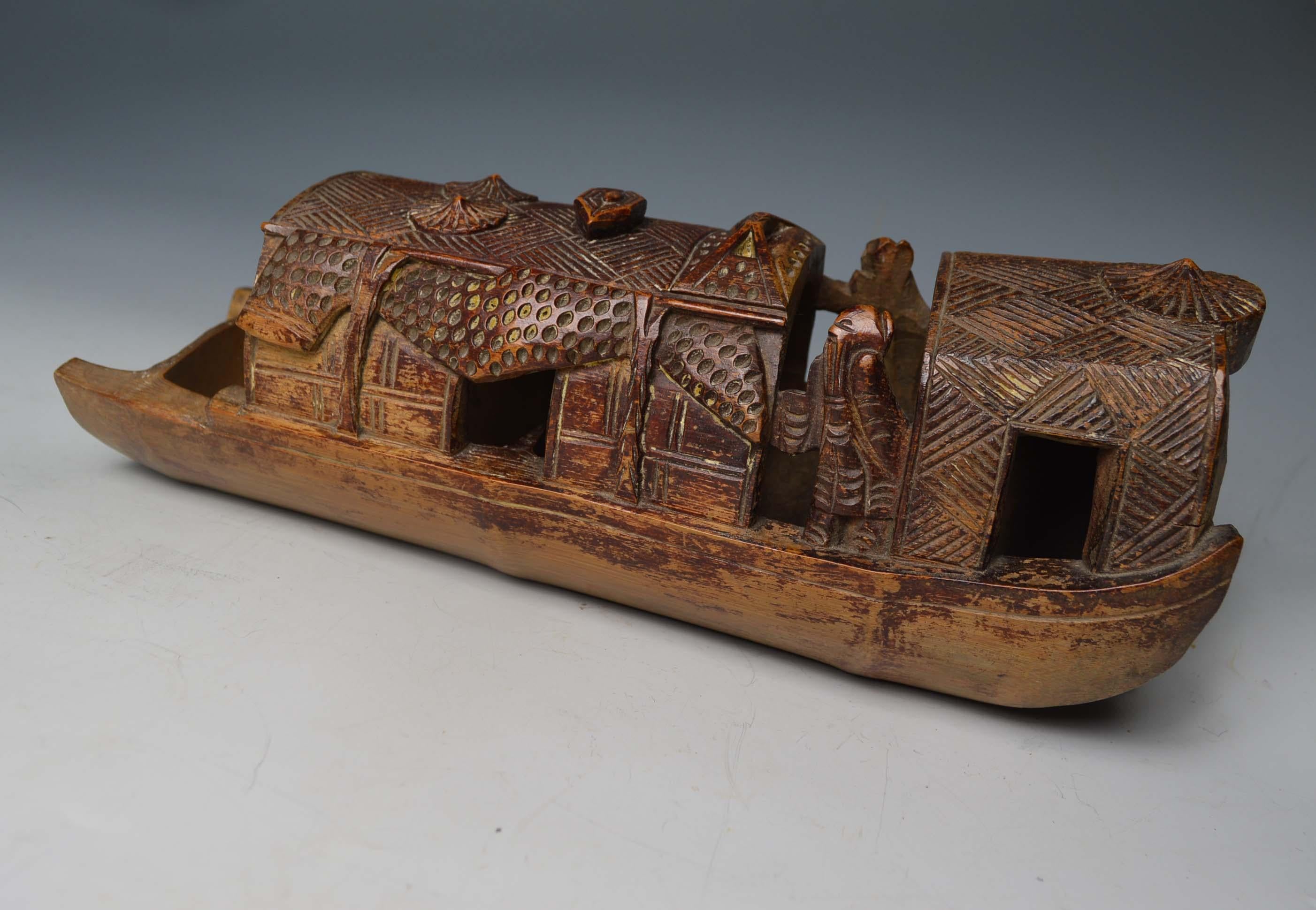 A fine antique Chinese carved bamboo brush pot
Carved as a house boat with standing robed figures 
Measures: Length 32 cm, width 11 cm 
Period late 19th century.