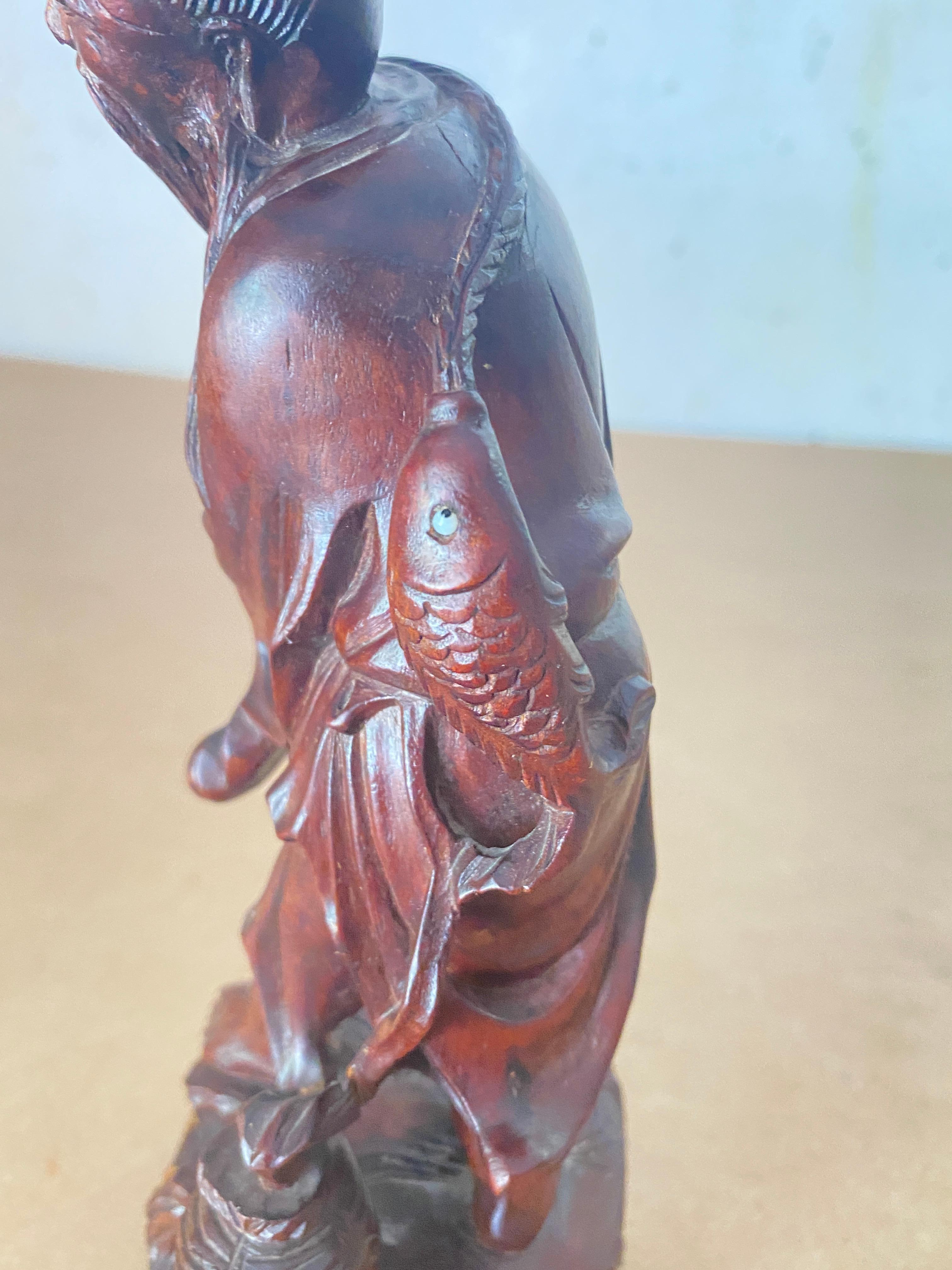 wooden fisherman statue