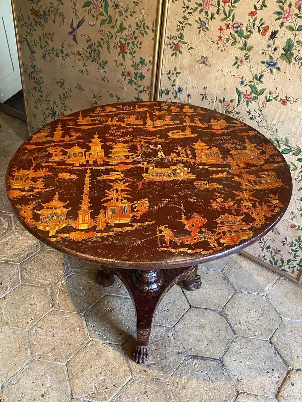 A fine quality Chinese export lacquer occasional table. 
Early 19th century, ca 1820.

The tilt top with typical exotic scenes of people, pagodas, lakes, foliage, bridges, fishermen and boats, all set with interconnecting islands. 
On a deep, rich,