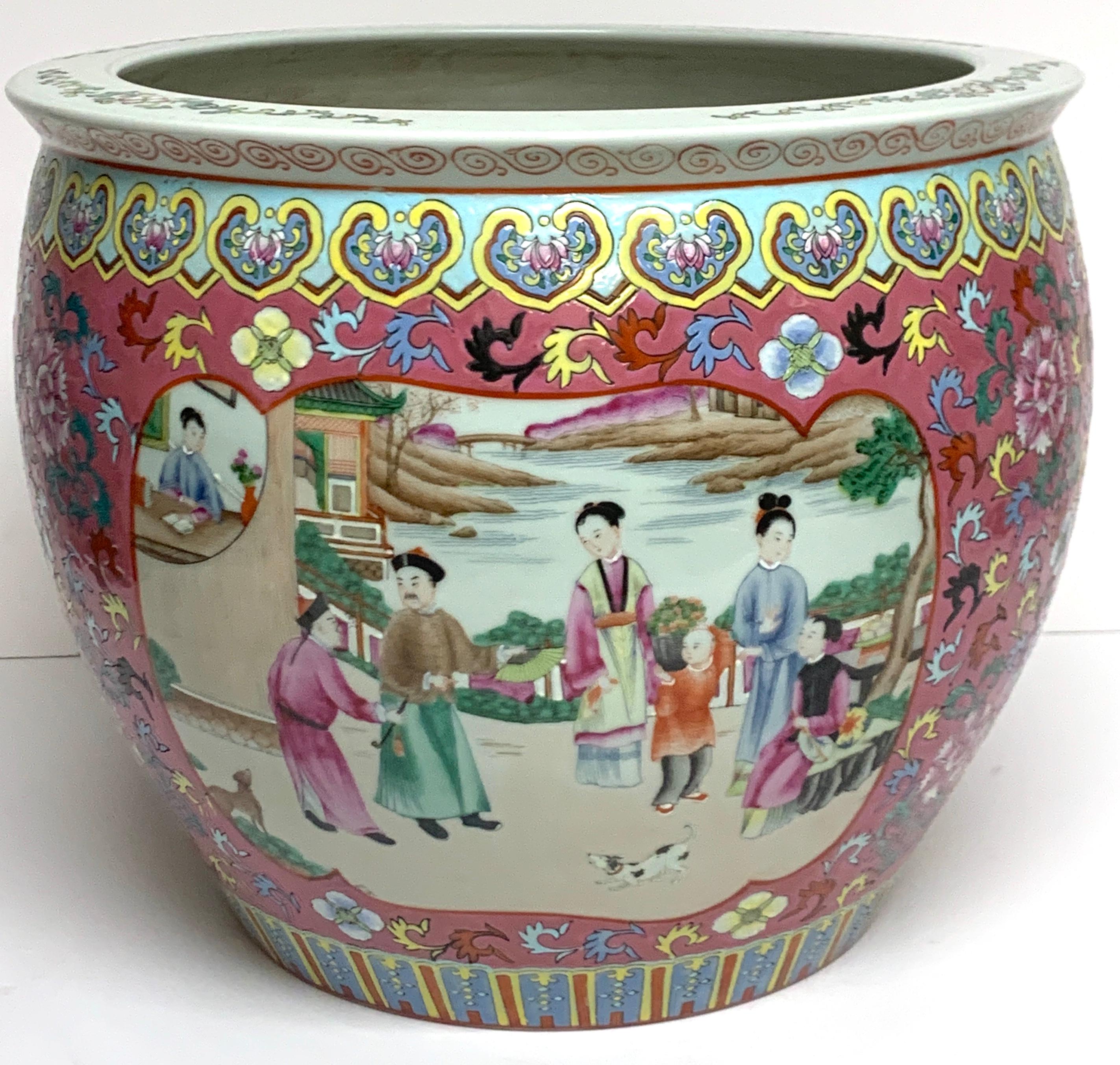 Fine Chinese Famille Verte fishbowl, with rich plum enameled background, two finely painted court scenes, the interior painted with goldfish and foliage. The bottom with a square red reign mark
The interior measures: 11.5