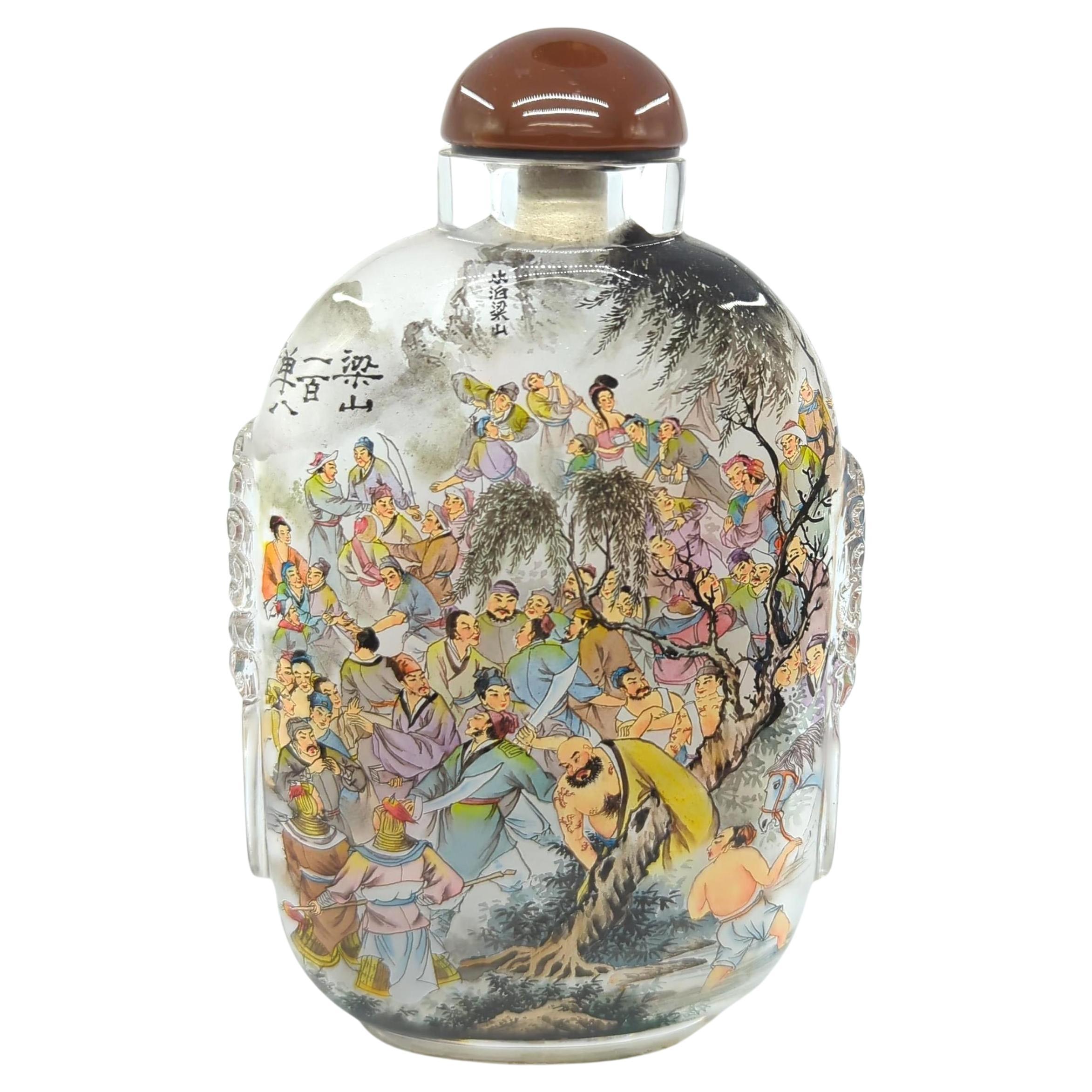 This remarkable glass snuff bottle, crafted by the esteemed artist Ya Qing in the spring of 2009, is a masterful example of inside painting. The bottle showcases an intricate depiction of the 108 warrior figures from Liang Mountain, as immortalized