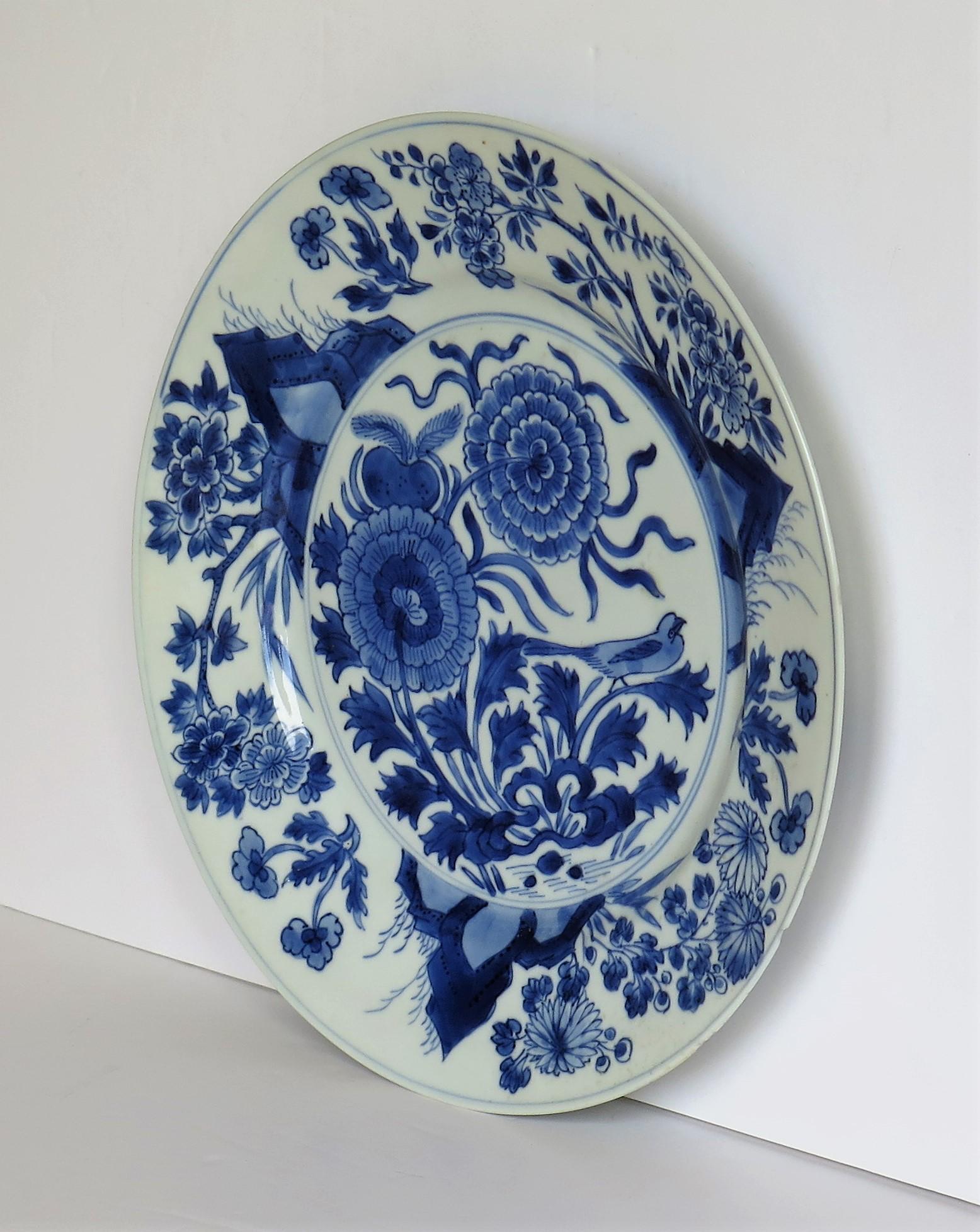 This is a beautifully hand painted Chinese porcelain blue and white plate from the Qing, Kangxi period, 1662-1722.

The plate is finely potted with a carefully cut base rim and a lovely rich glassy white glaze, with a very light blue tinge.

The
